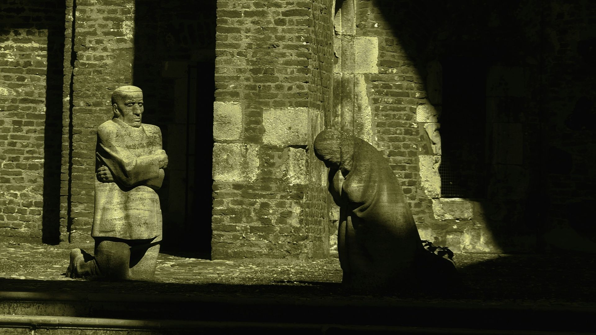 a person standing next to a statue