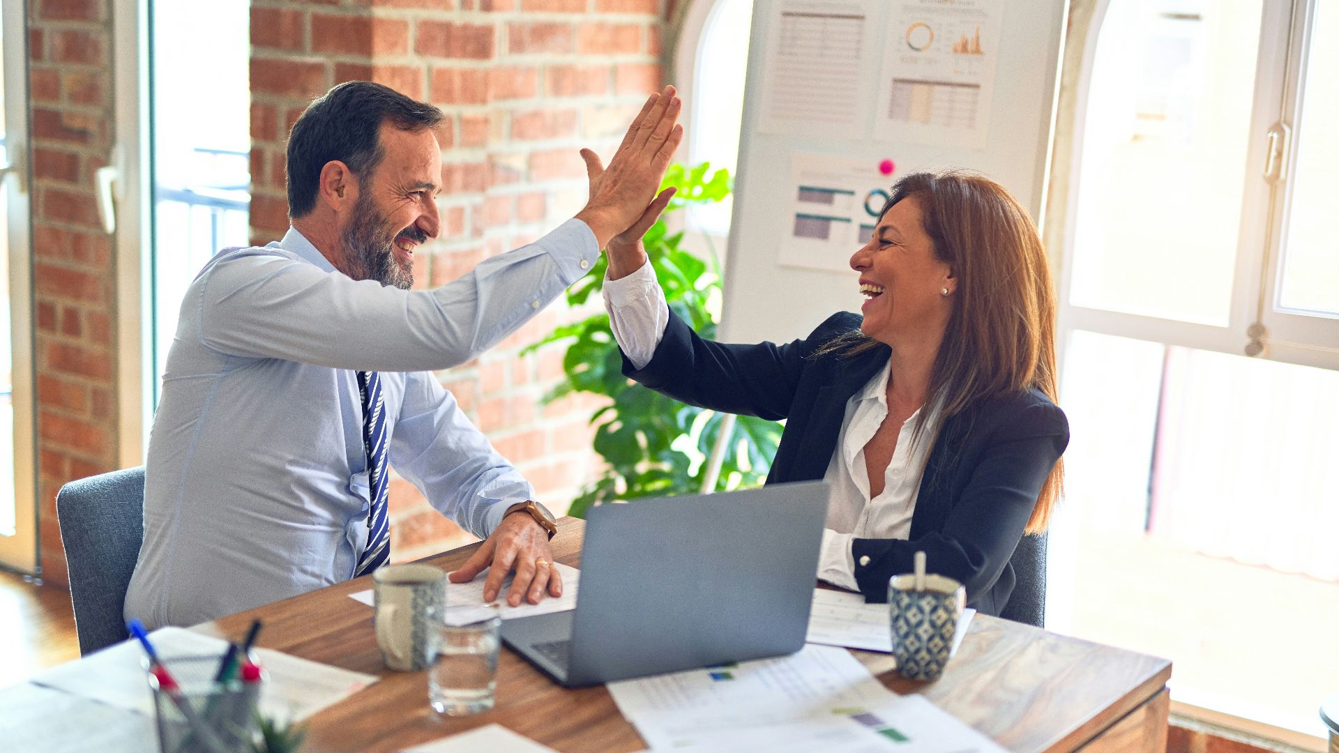 man in white dress shirt sitting beside woman in black long sleeve shirt