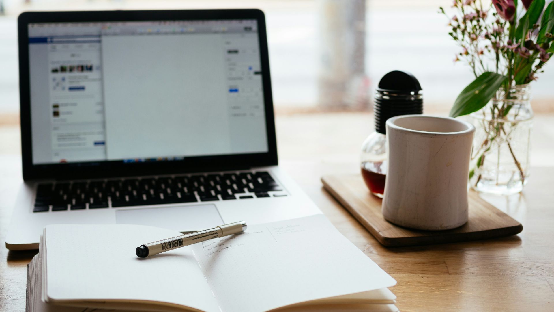 MacBook Pro near white open book