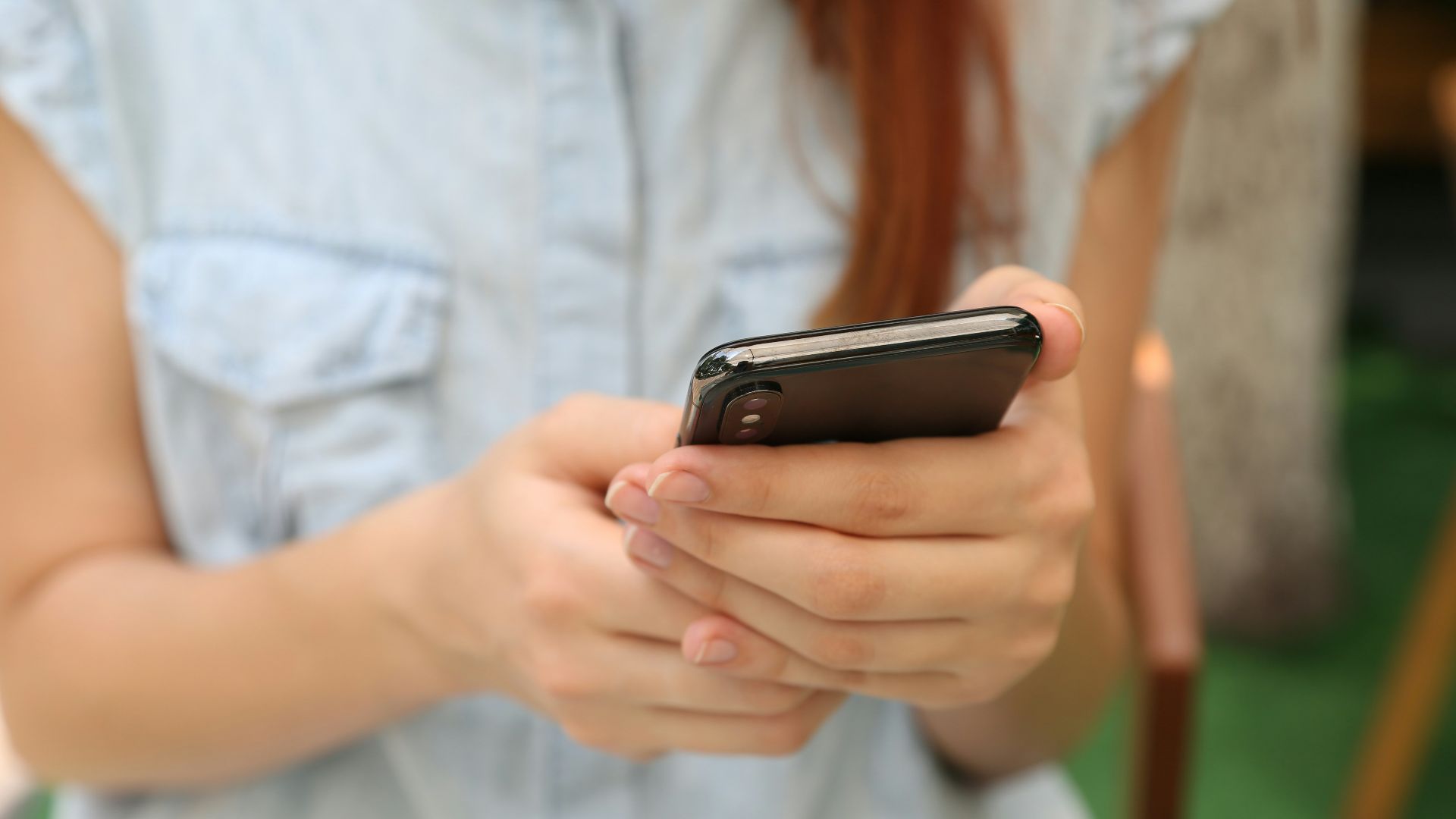 person holding using iPhone X