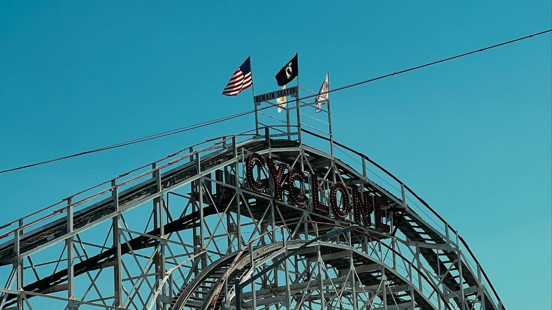A roller coaster with flags on top of it