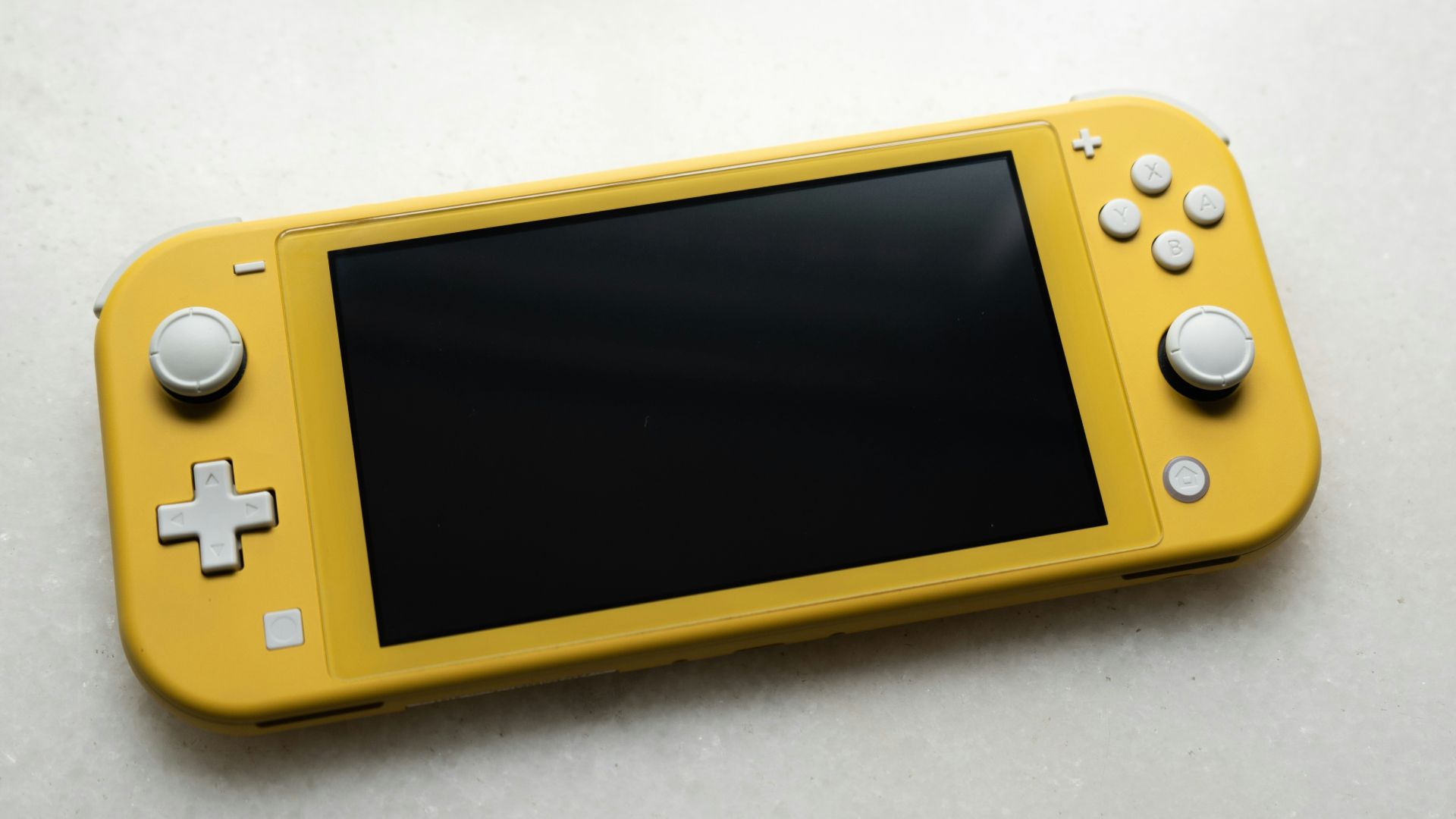 yellow nintendo game boy on white table