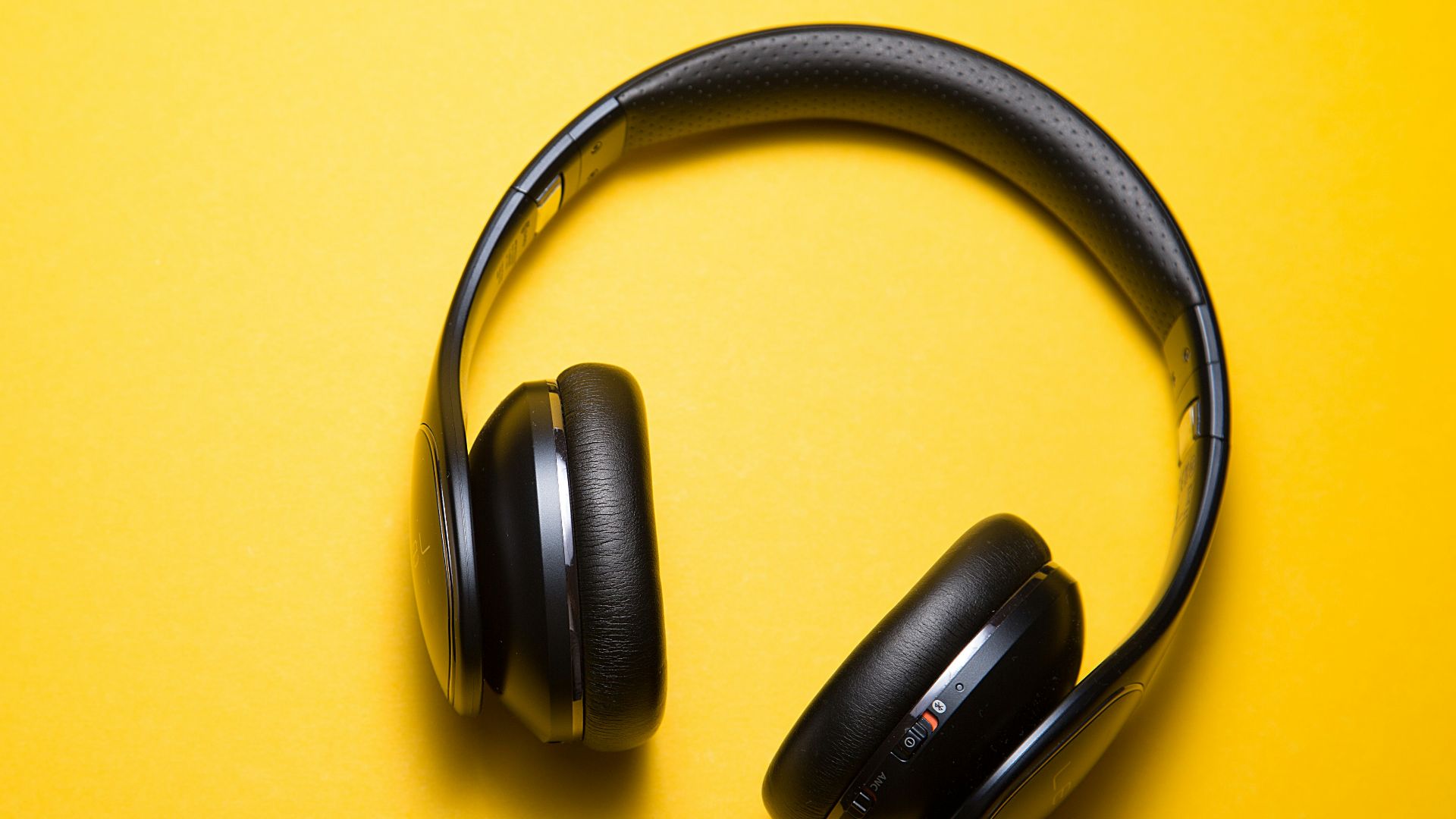 flatlay photography of wireless headphones