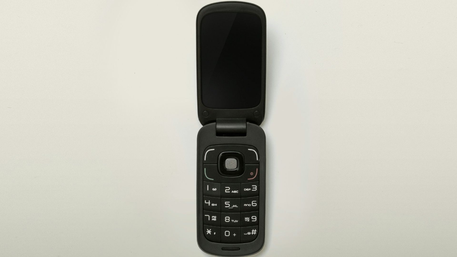 turned-off black flip-phone