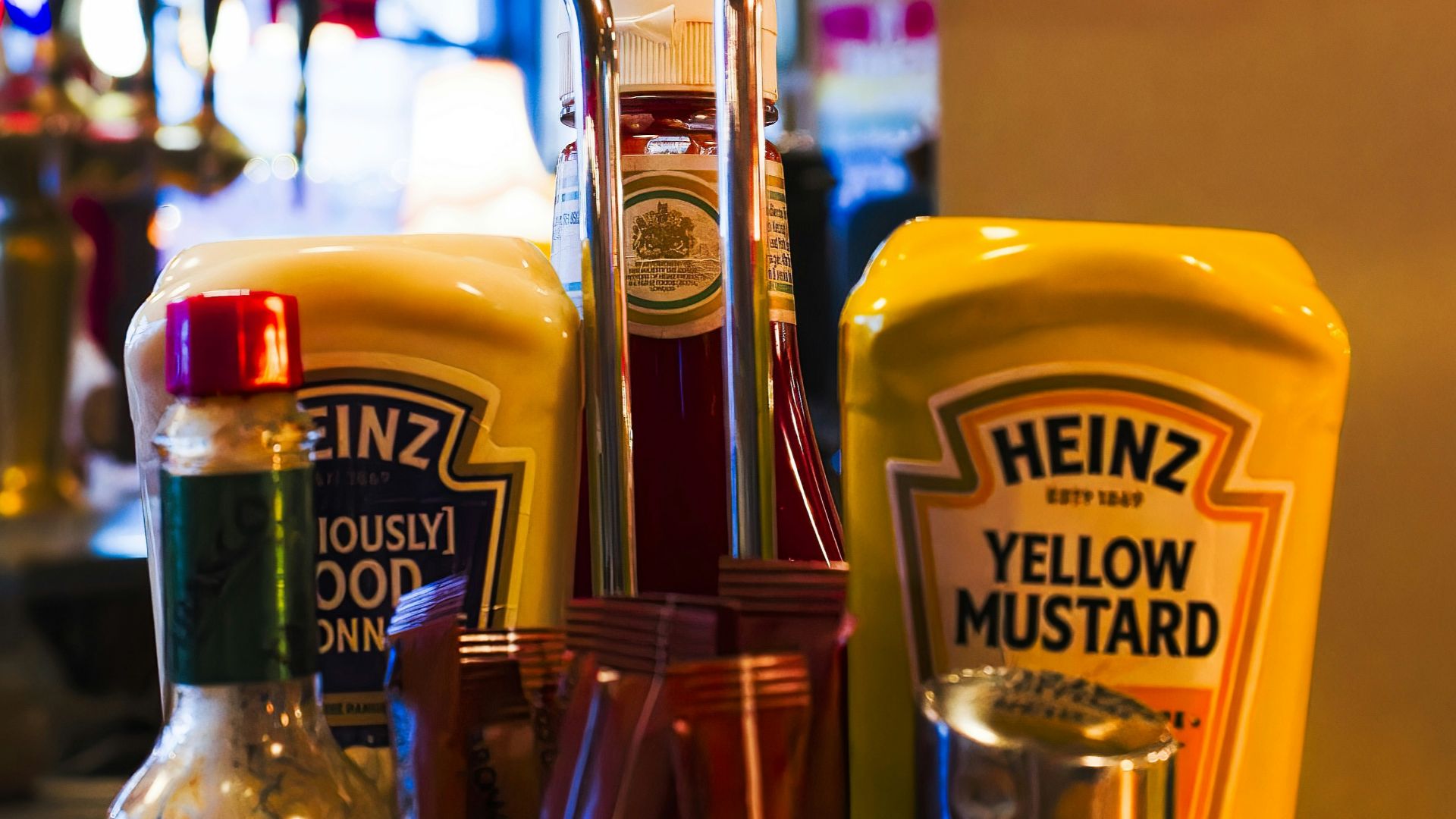 a basket of condiments sits on a counter in a restaurant