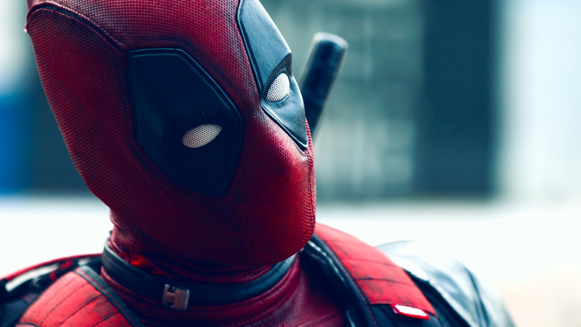 a man in a deadpool costume with a knife in his hand