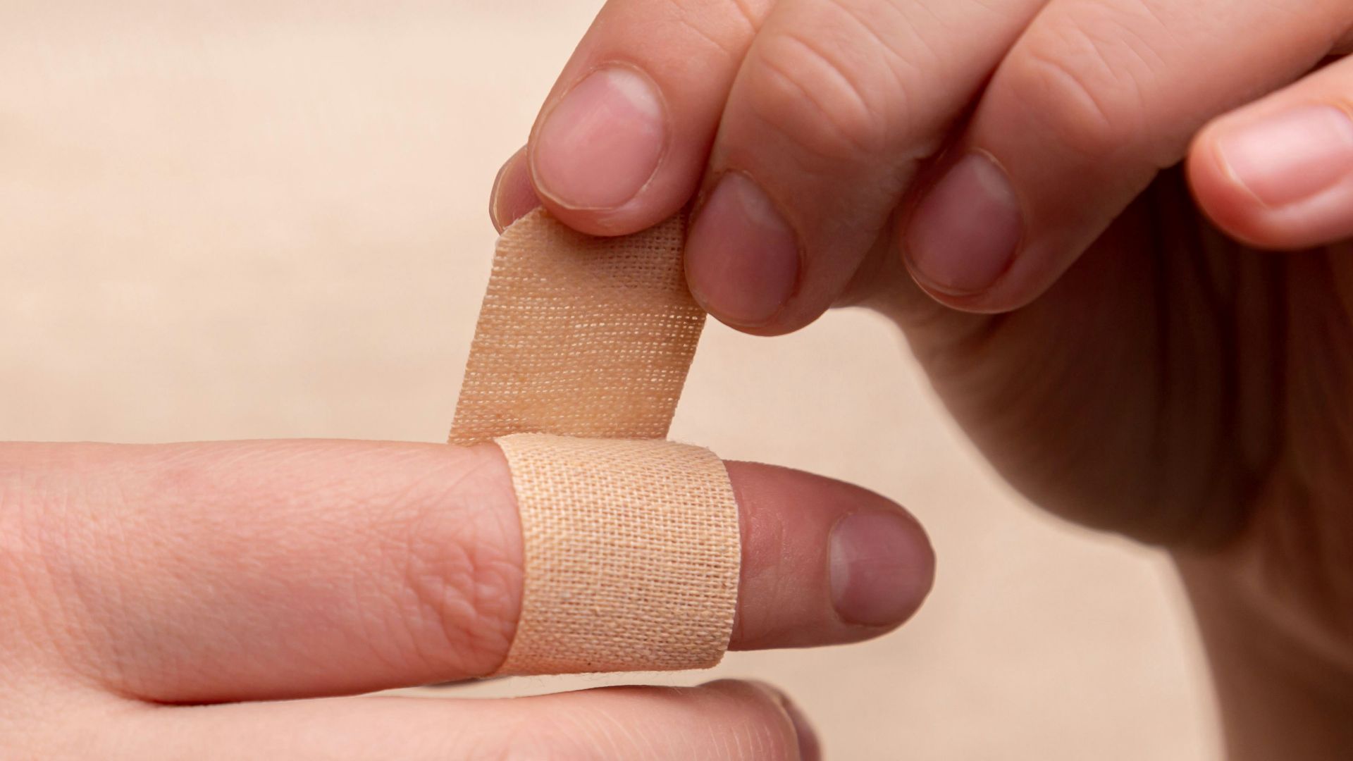 person with band aid on middle finger