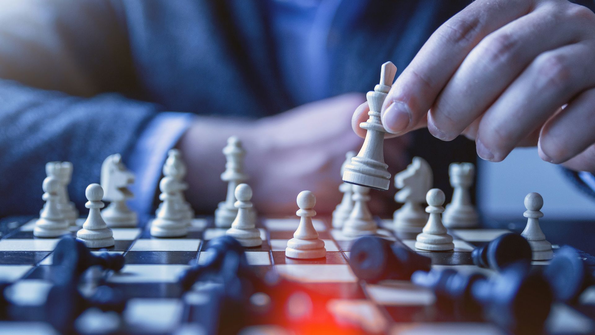depth of field photography of man playing chess