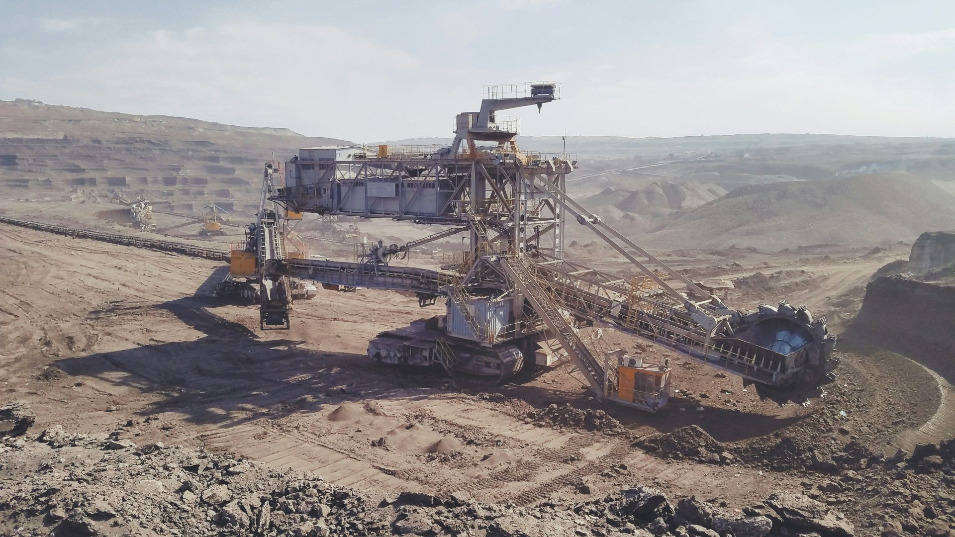 gray heavy equipment on vast land during daytime