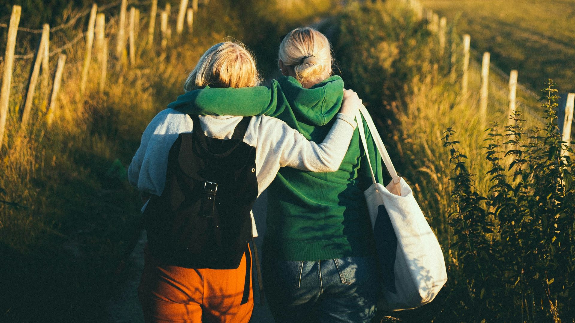 two women walking together outdoor during daytime