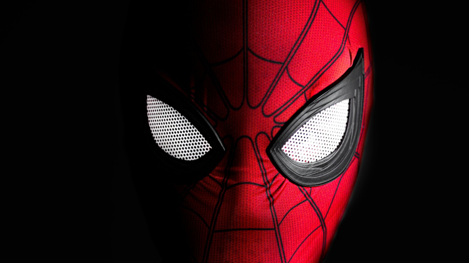 a close up of a spider man with glowing eyes