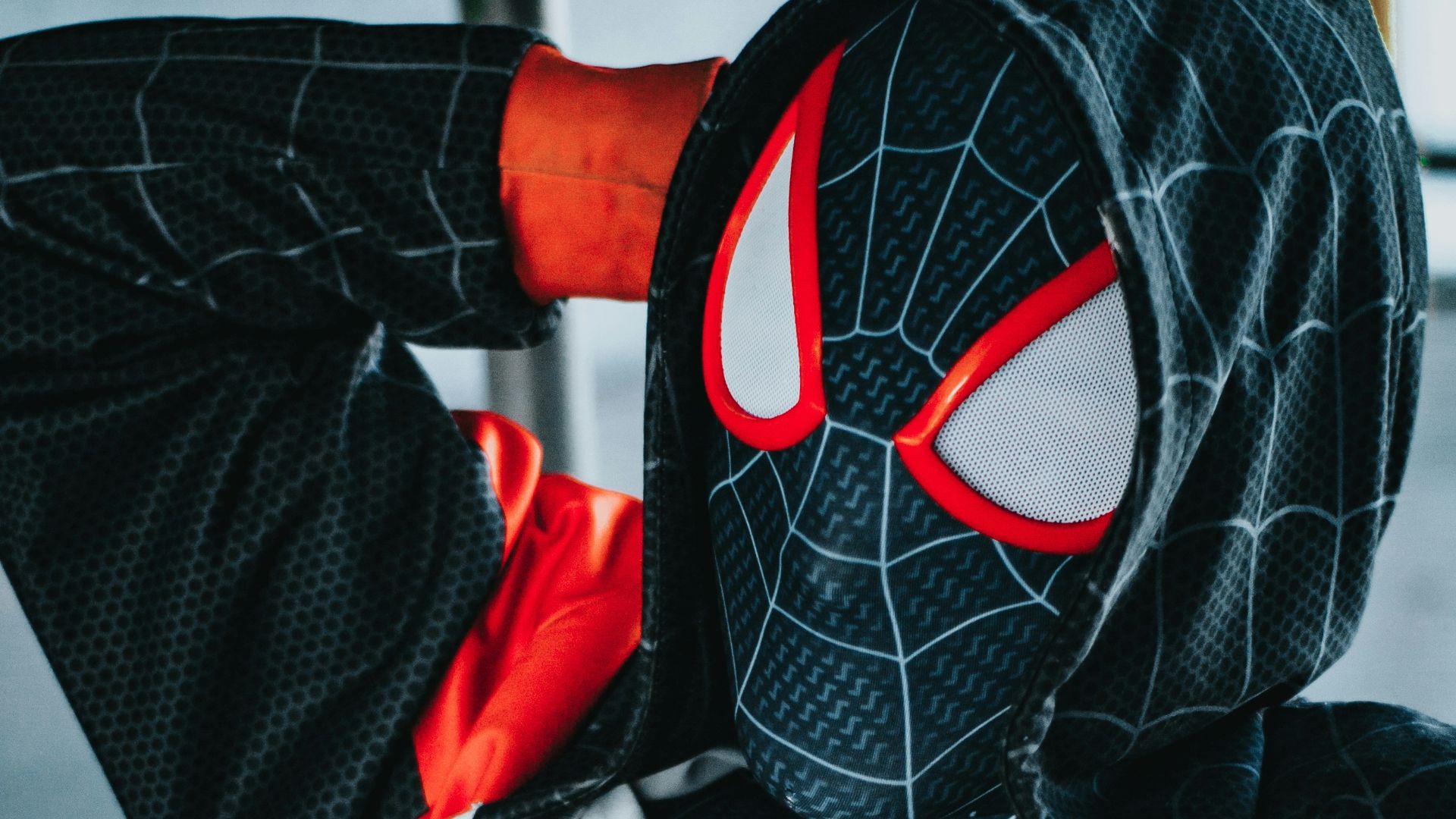 a spider man is sitting on a bench