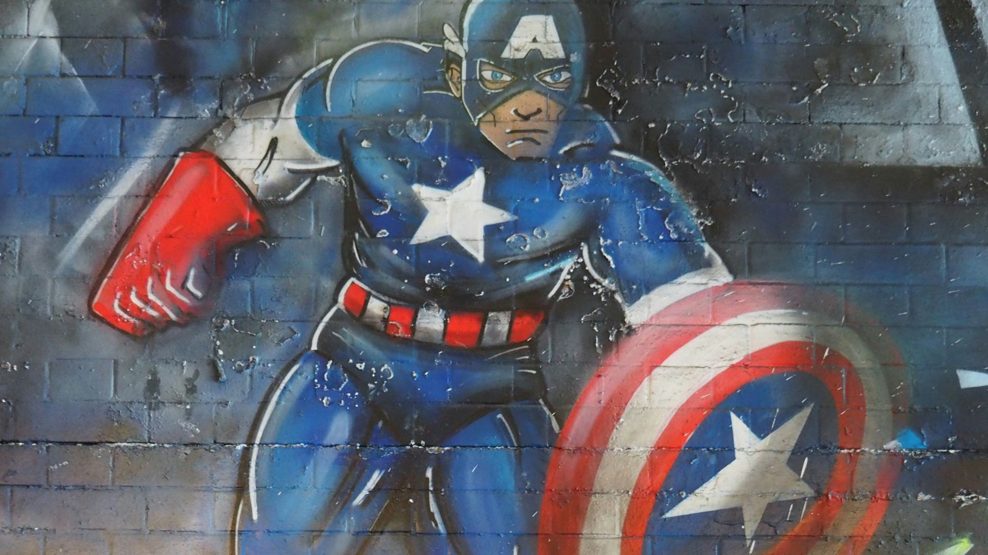 man in blue and red suit holding red and blue shield