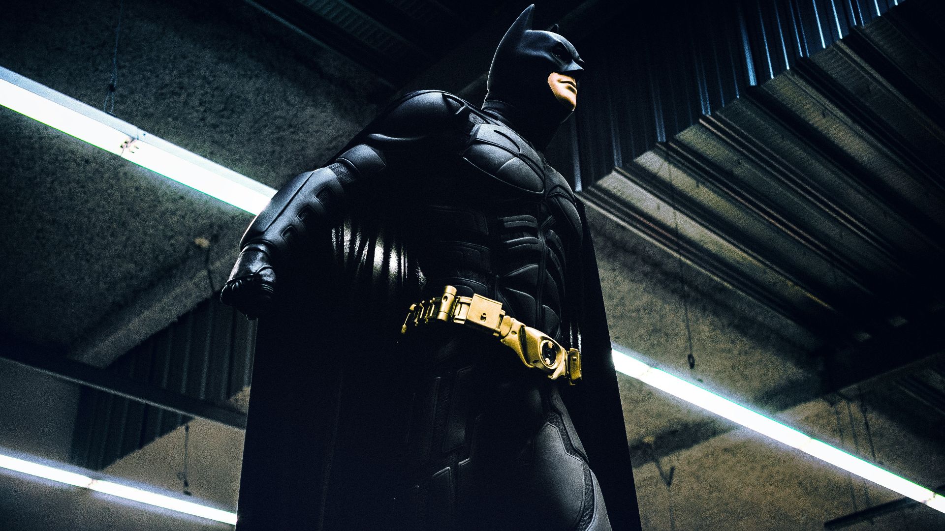 Batman standing under steel roof