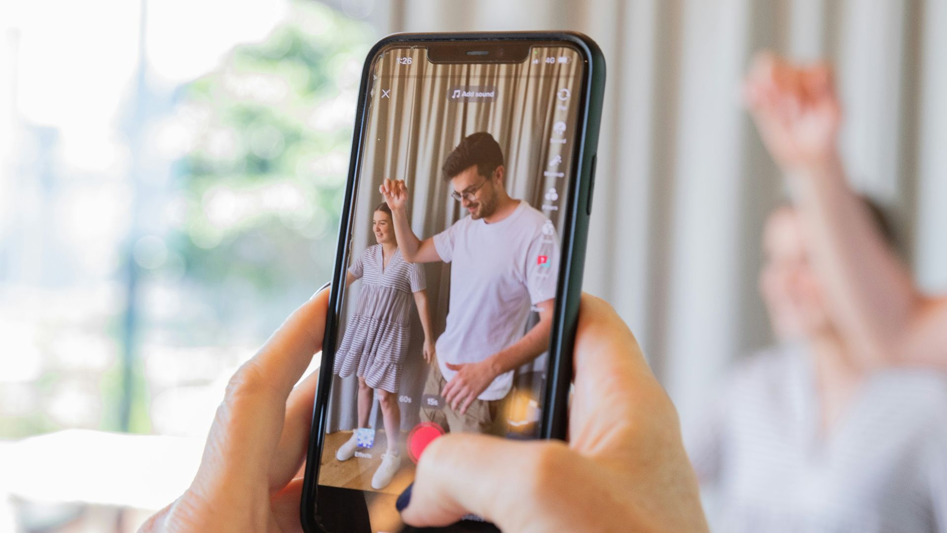 a person taking a picture of a man and woman