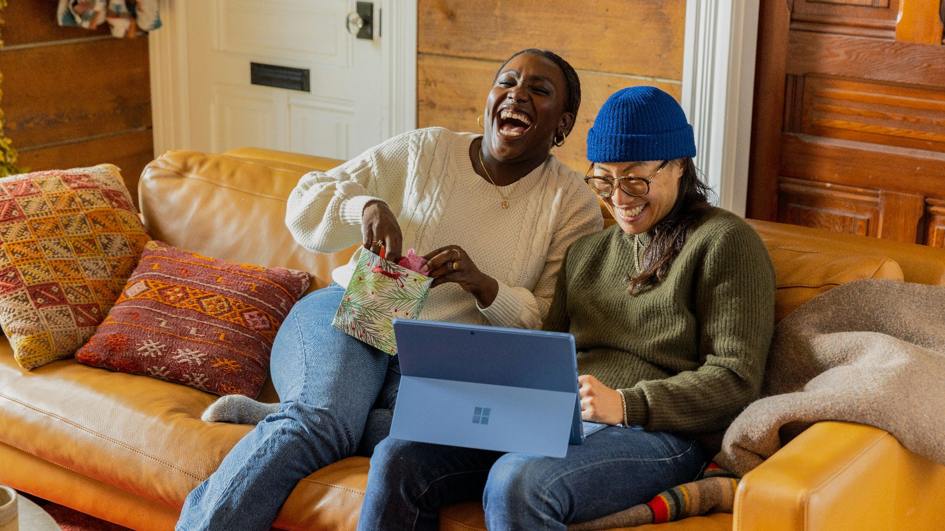 a person sitting on a couch with a laptop