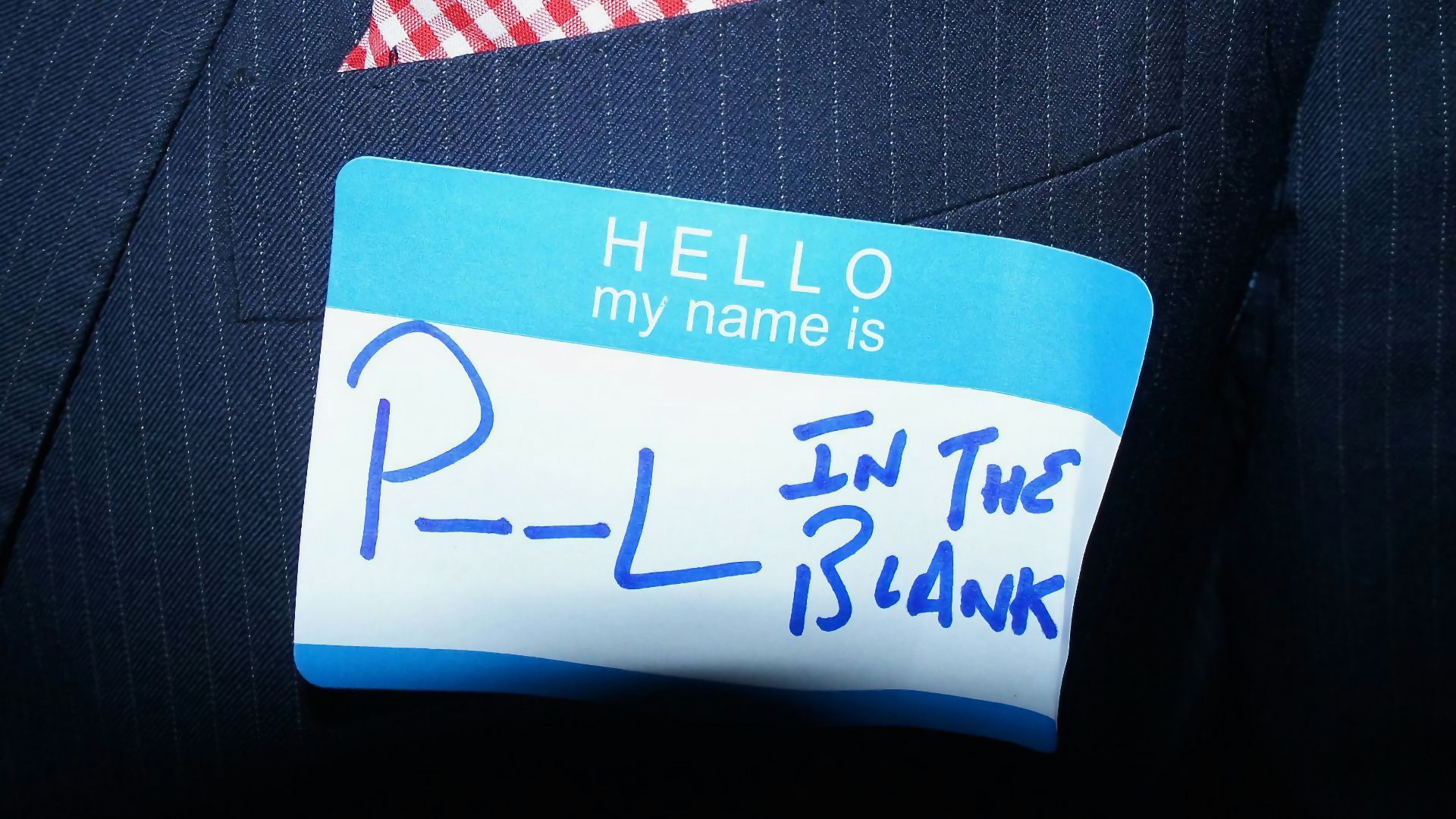 a close up of a person wearing a suit and tie