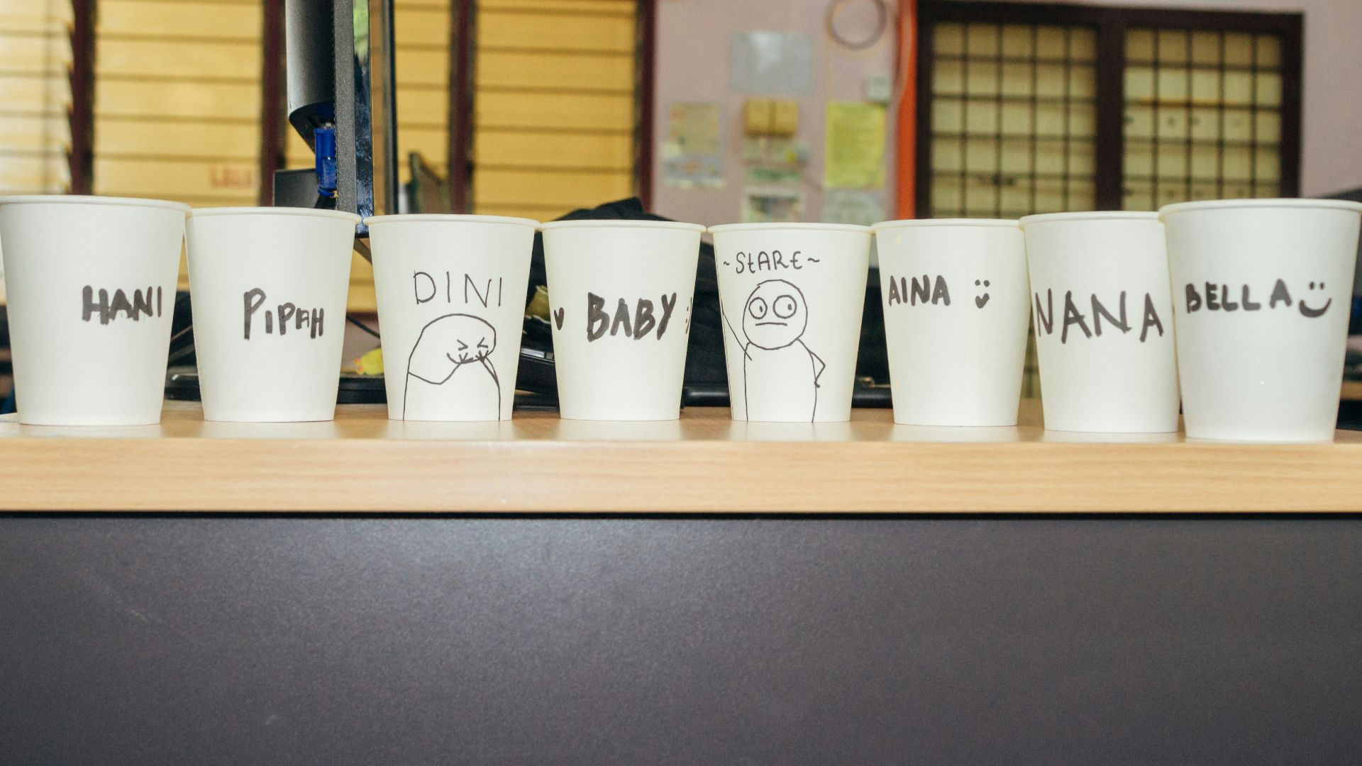 a row of white cups sitting on top of a counter