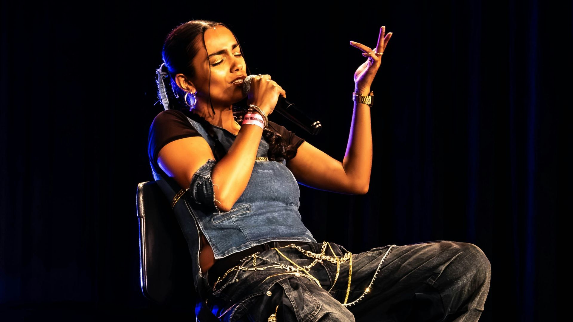 A man sitting in a chair on a stage
