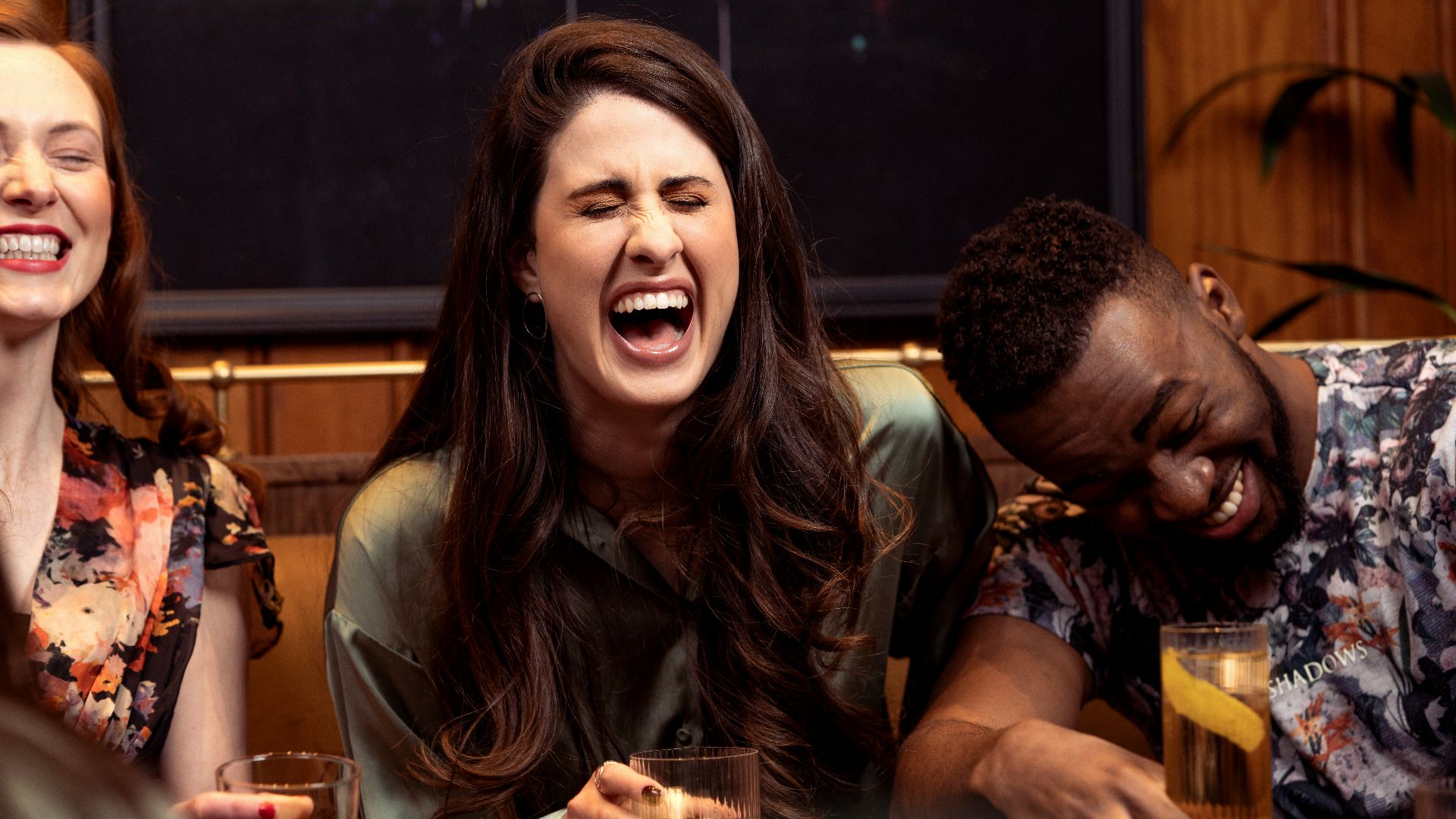 a group of people sitting around a table with drinks