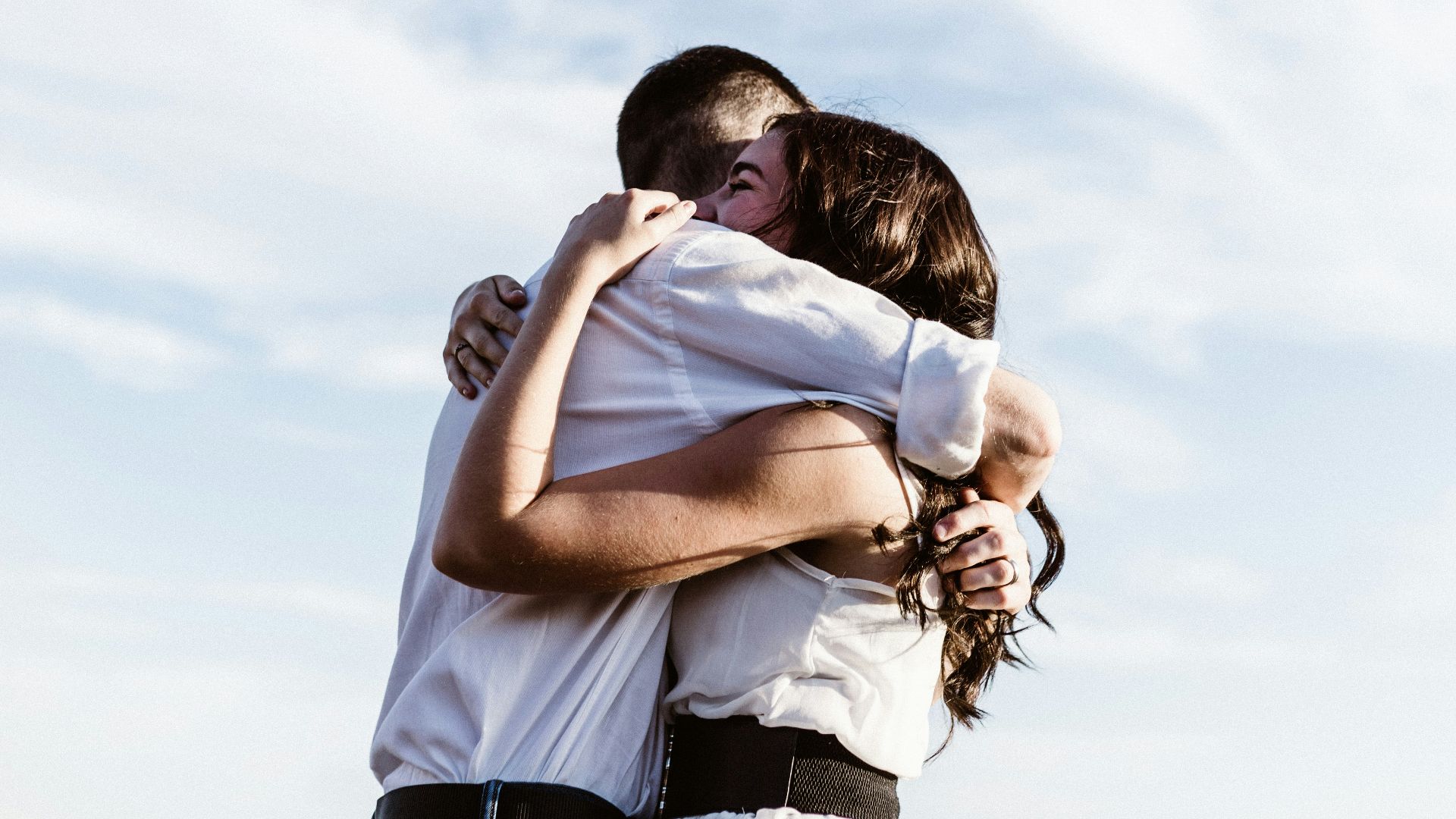 man and woman hugging each other photography