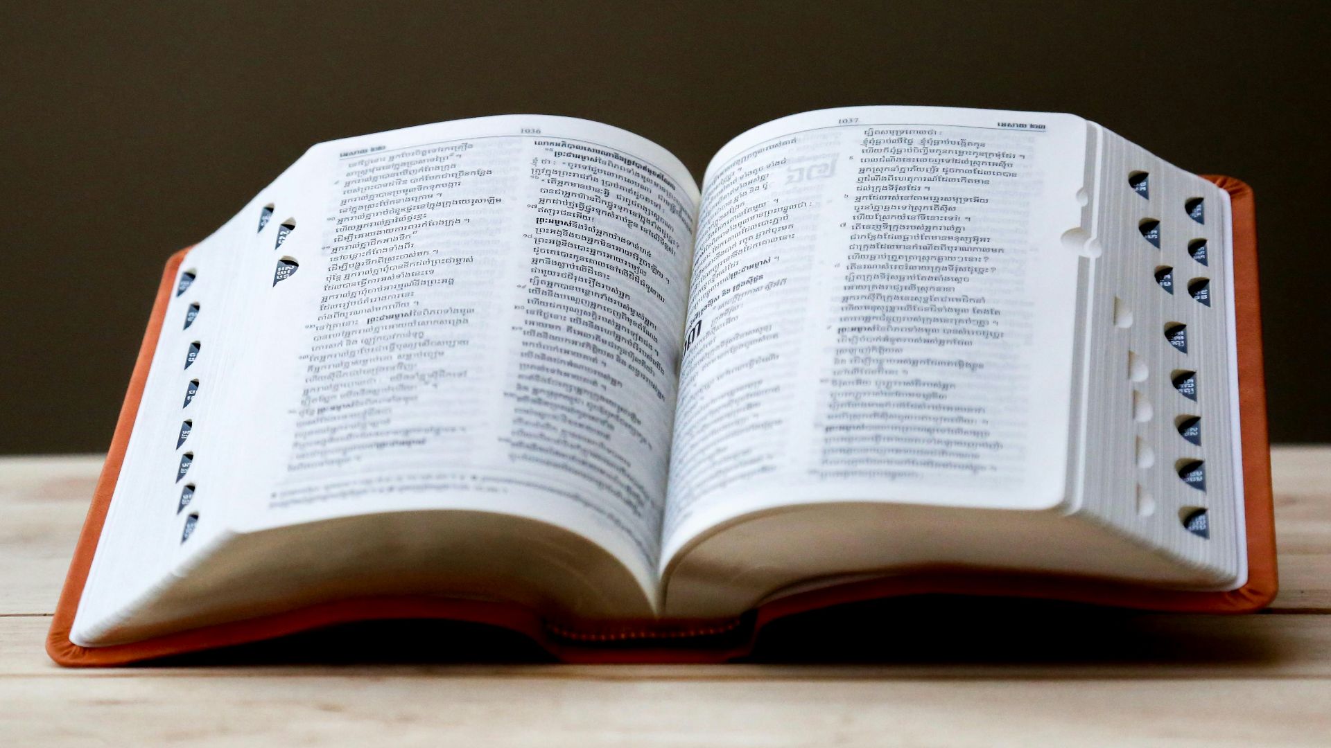 opened book on brown table