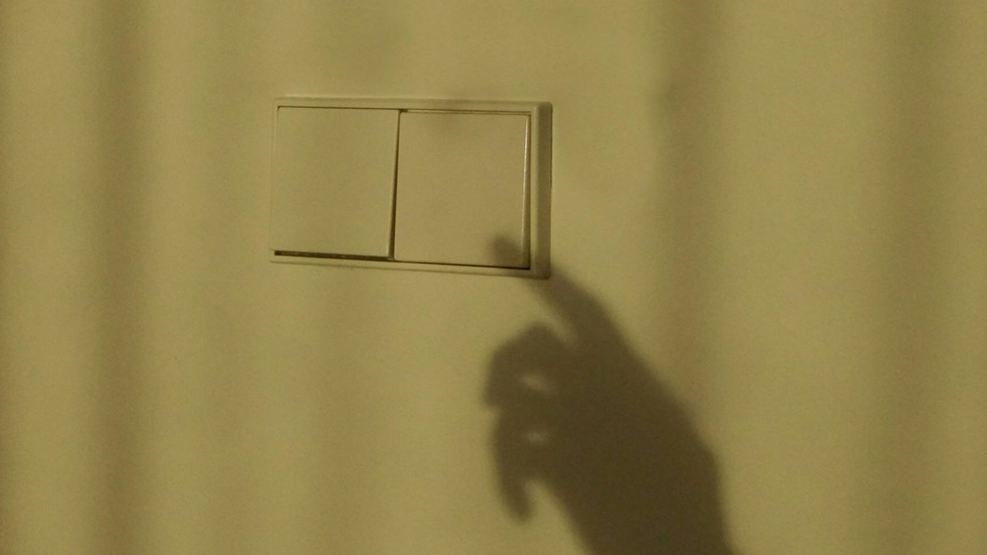 a shadow of a person holding a piece of paper