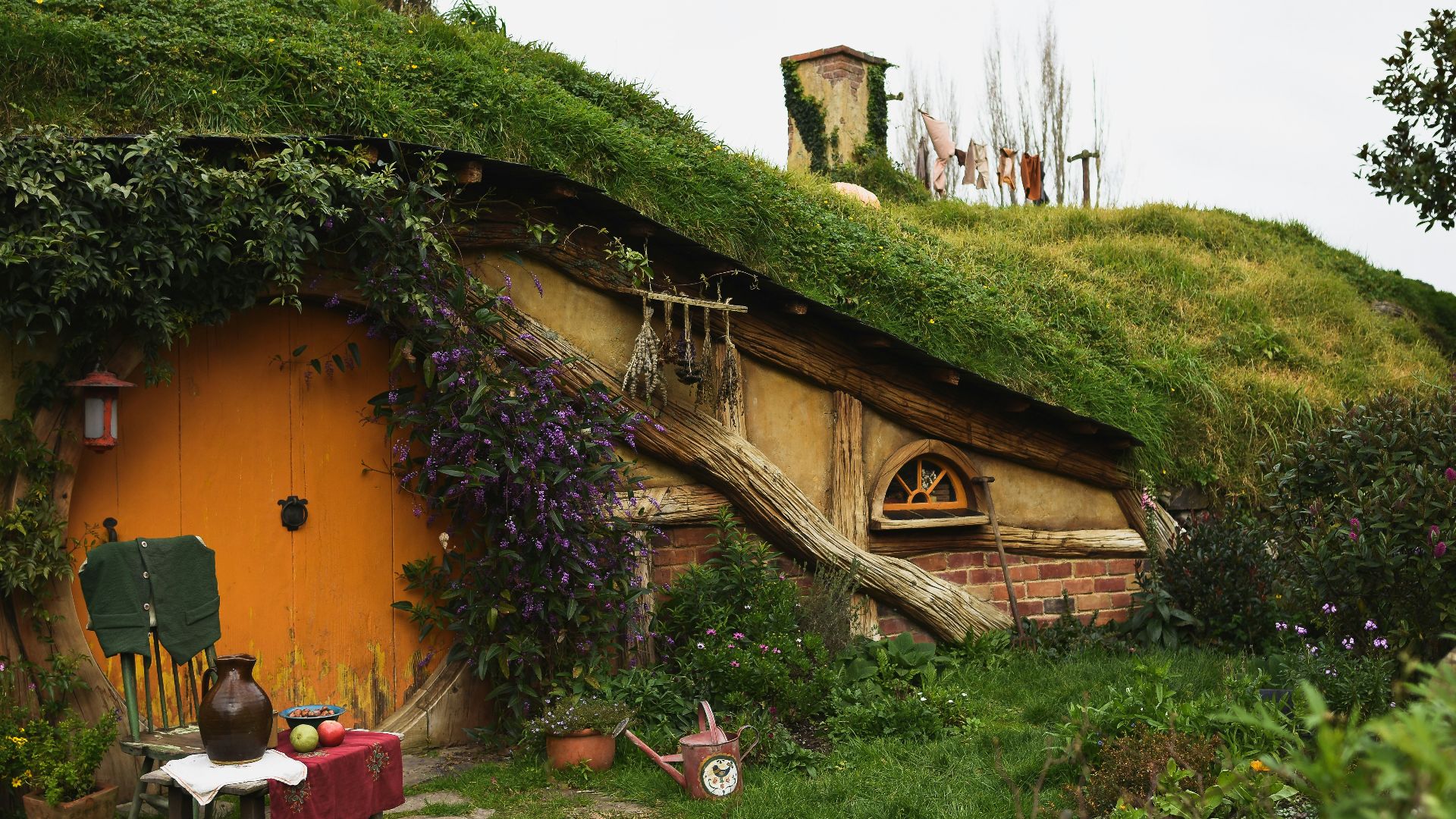 brown wooden house near green grass field during daytime