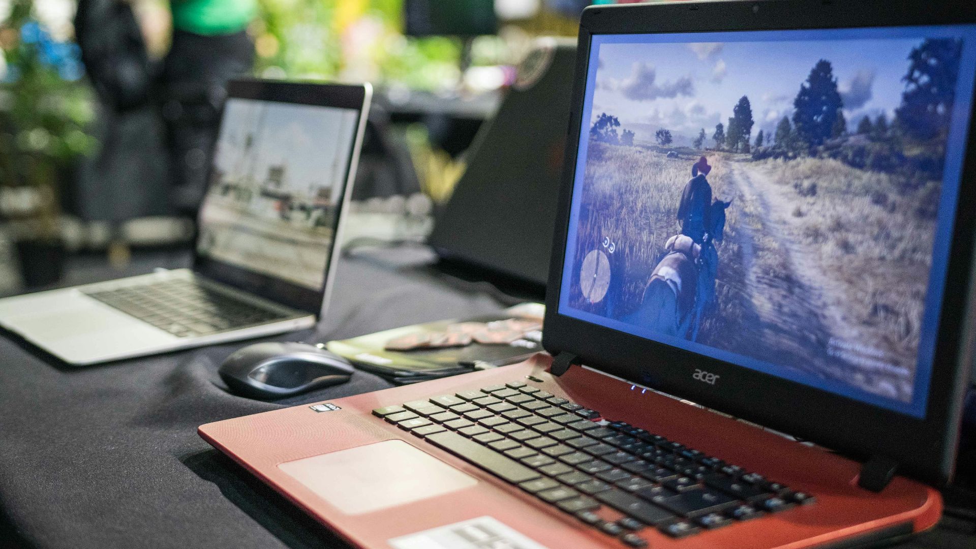 a couple of laptops sit on a table