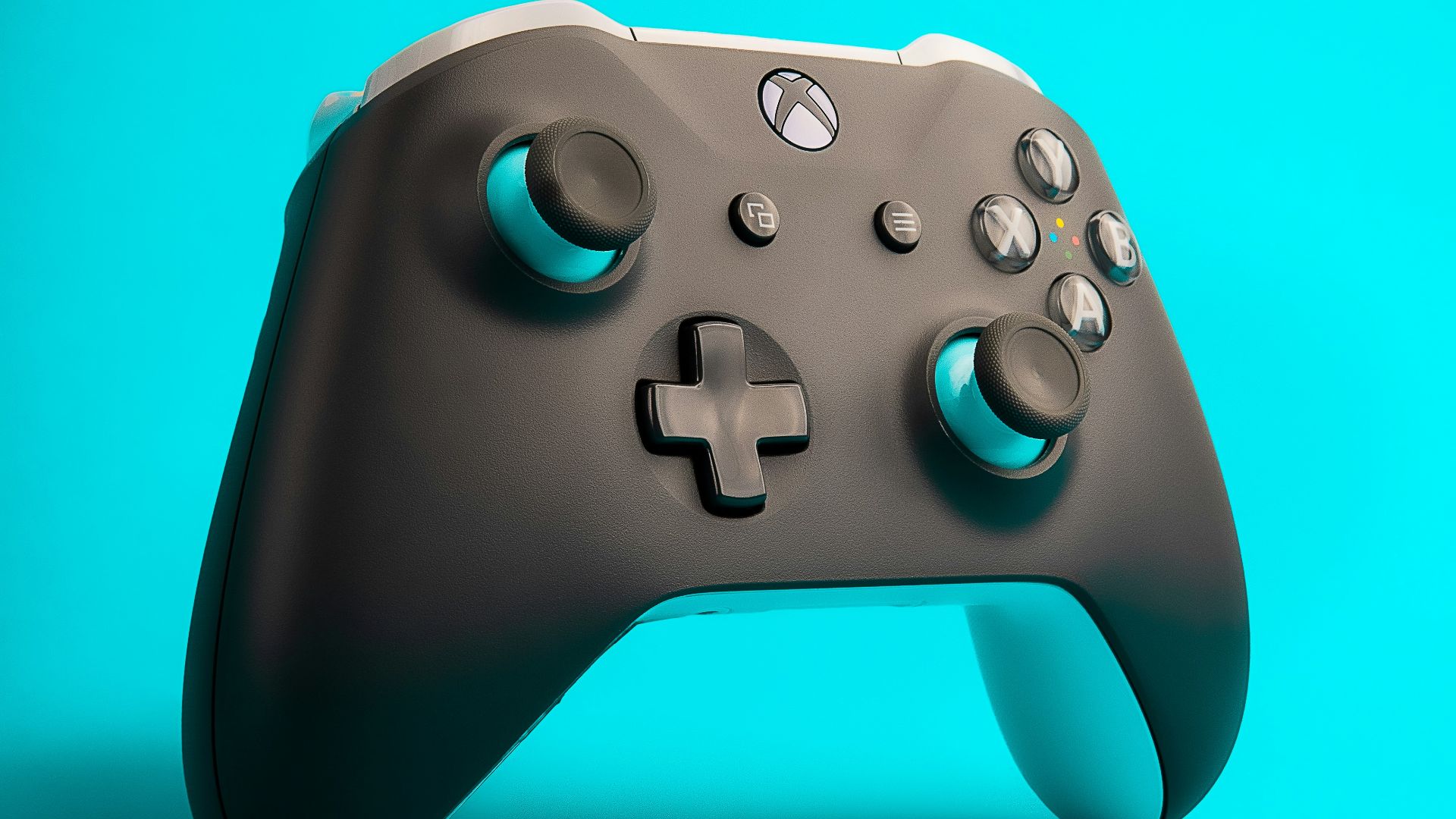 a close up of a controller on a blue background