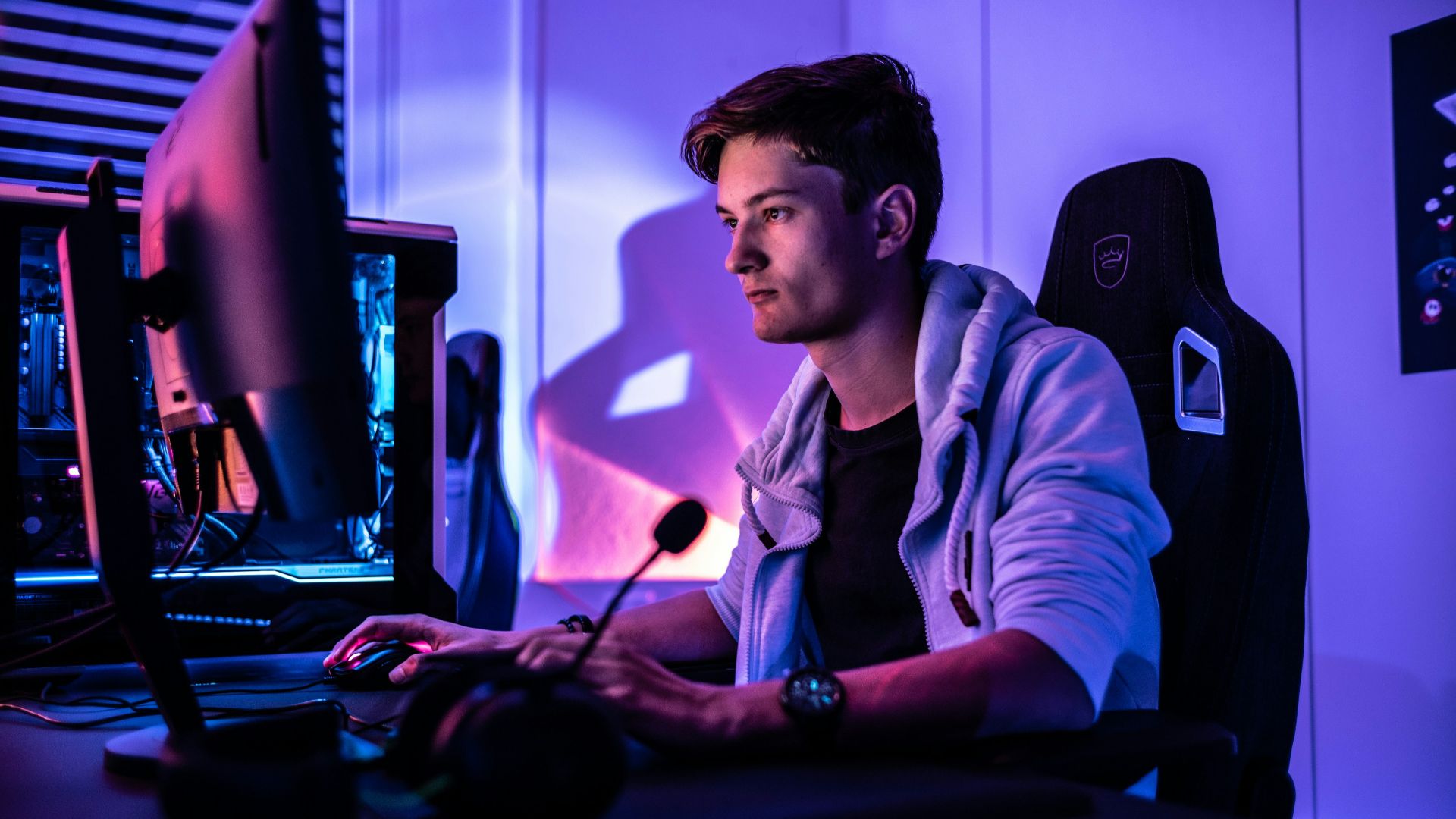 a man sitting in front of a computer monitor