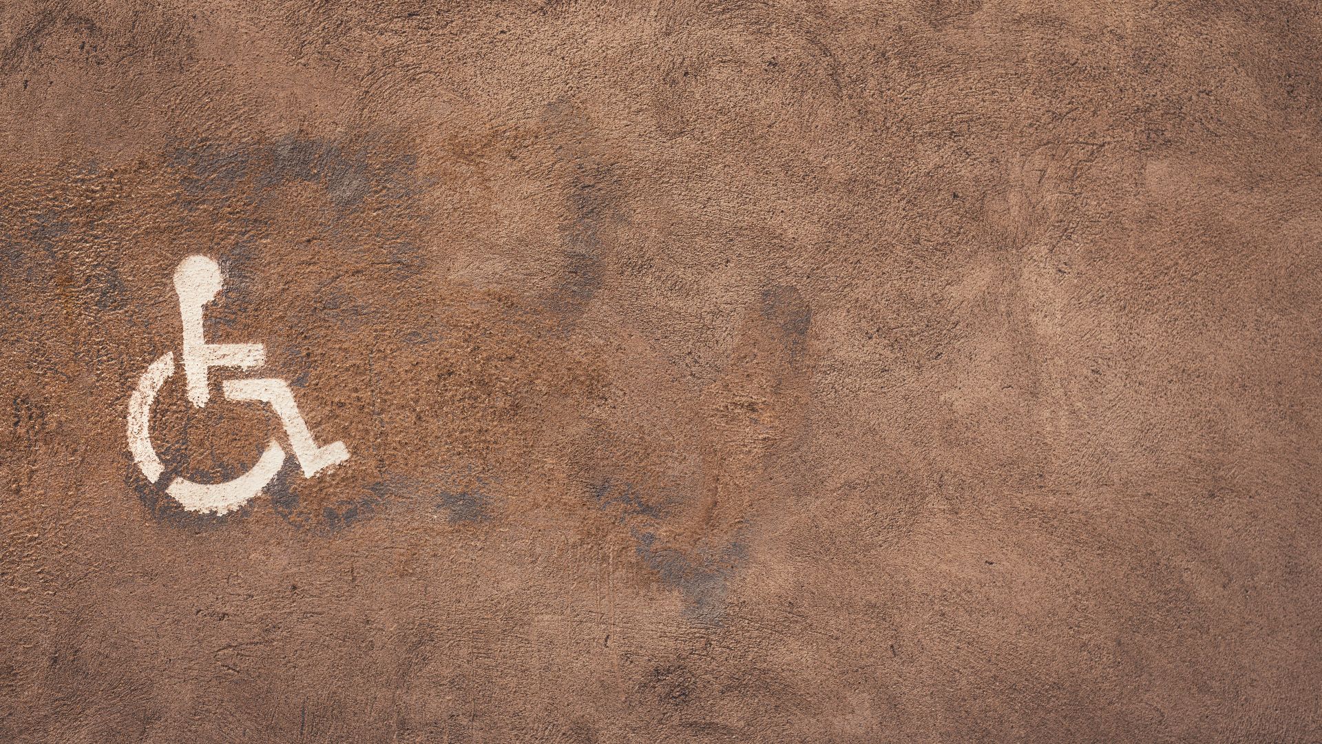 a handicap sign painted on the side of a wall