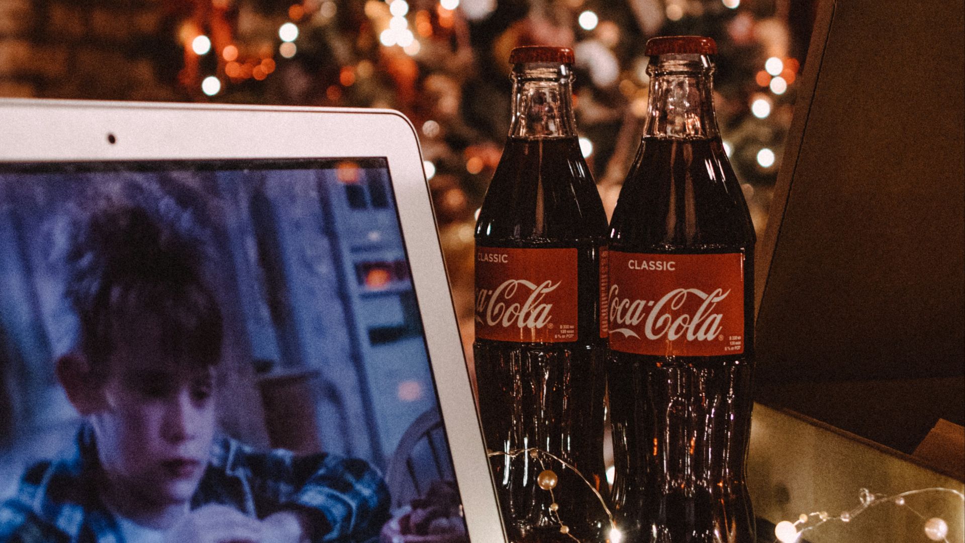 coca cola bottle beside white ipad