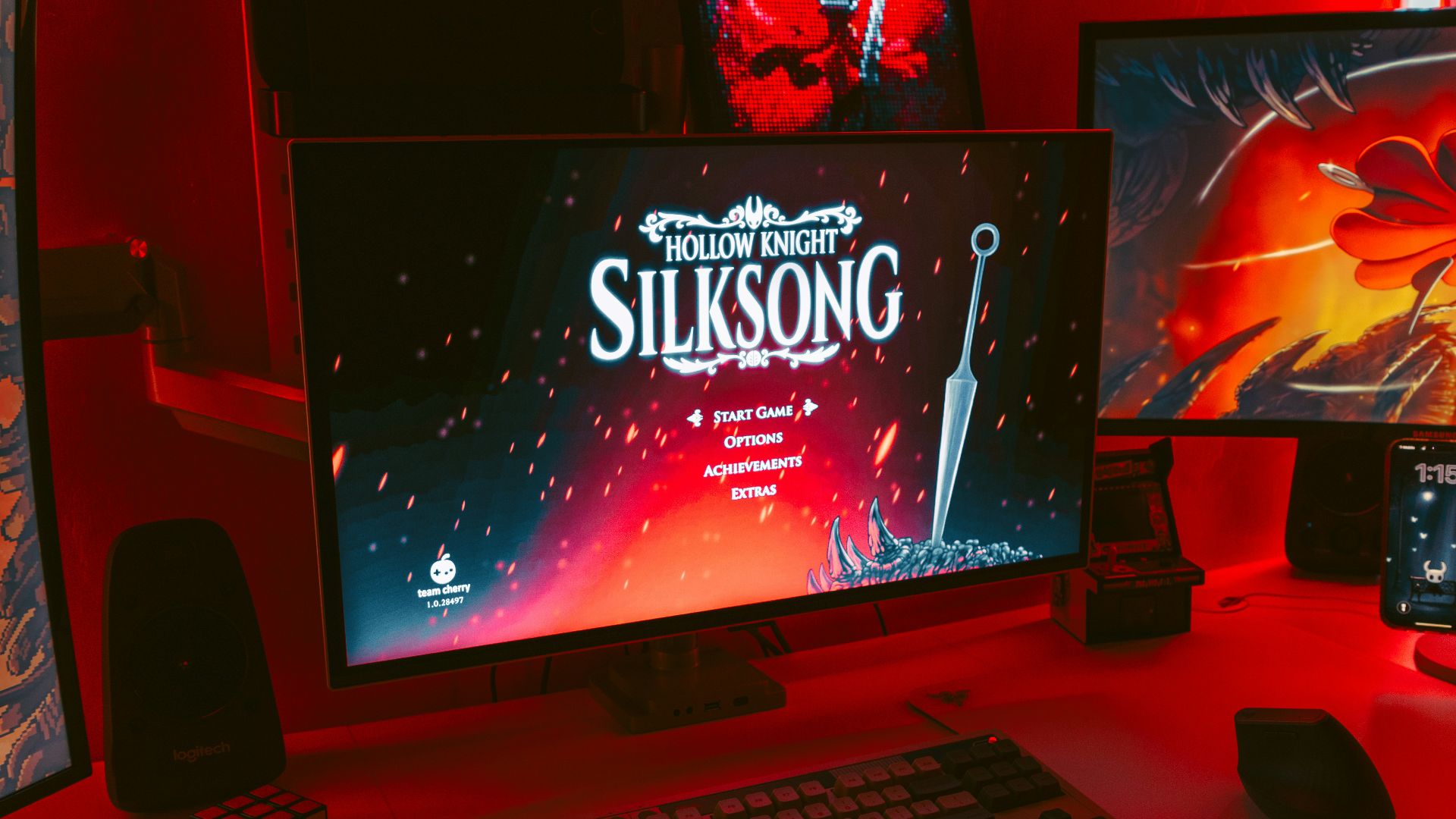 Gaming setup with multiple monitors displaying game art.