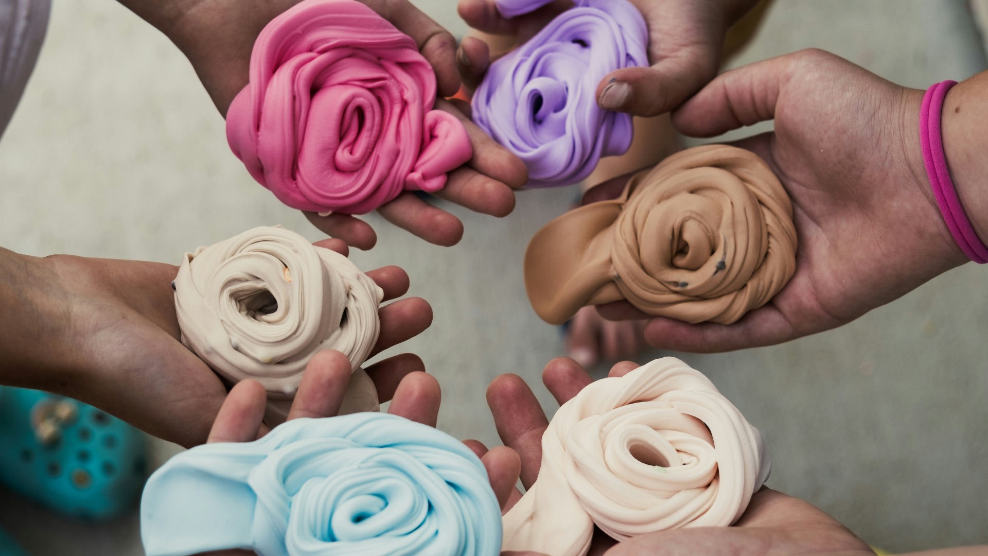 a group of people holding different colored flowers