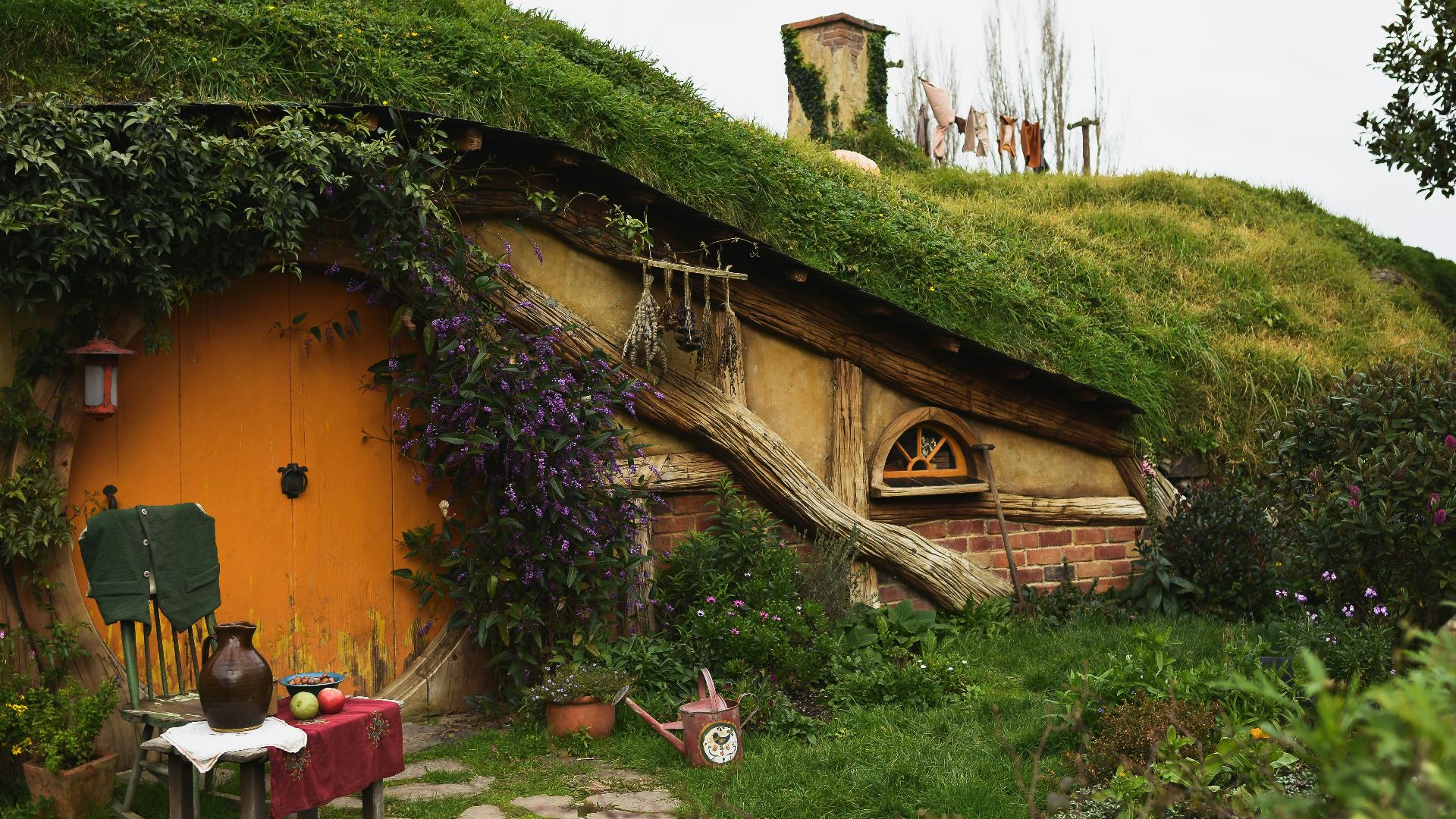 brown wooden house near green grass field during daytime
