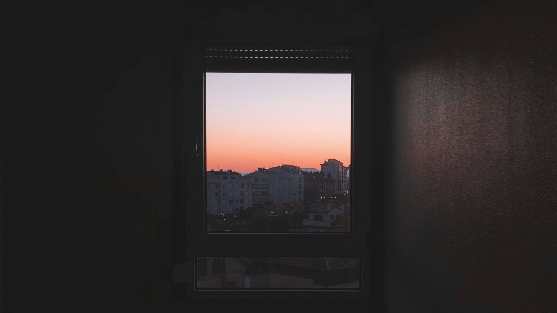 black flat screen tv turned on in dark room