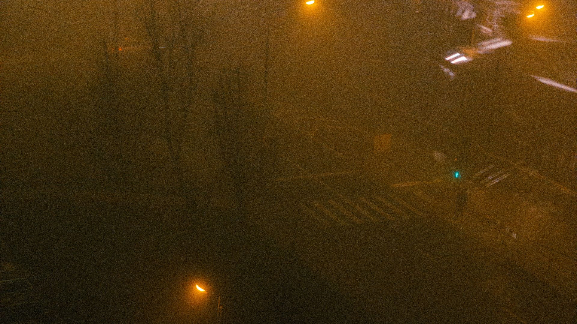 a parking lot filled with lots of cars on a foggy night