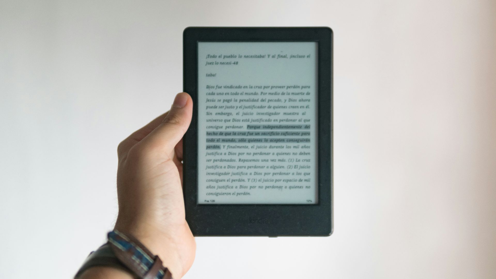 person holding black e book reader