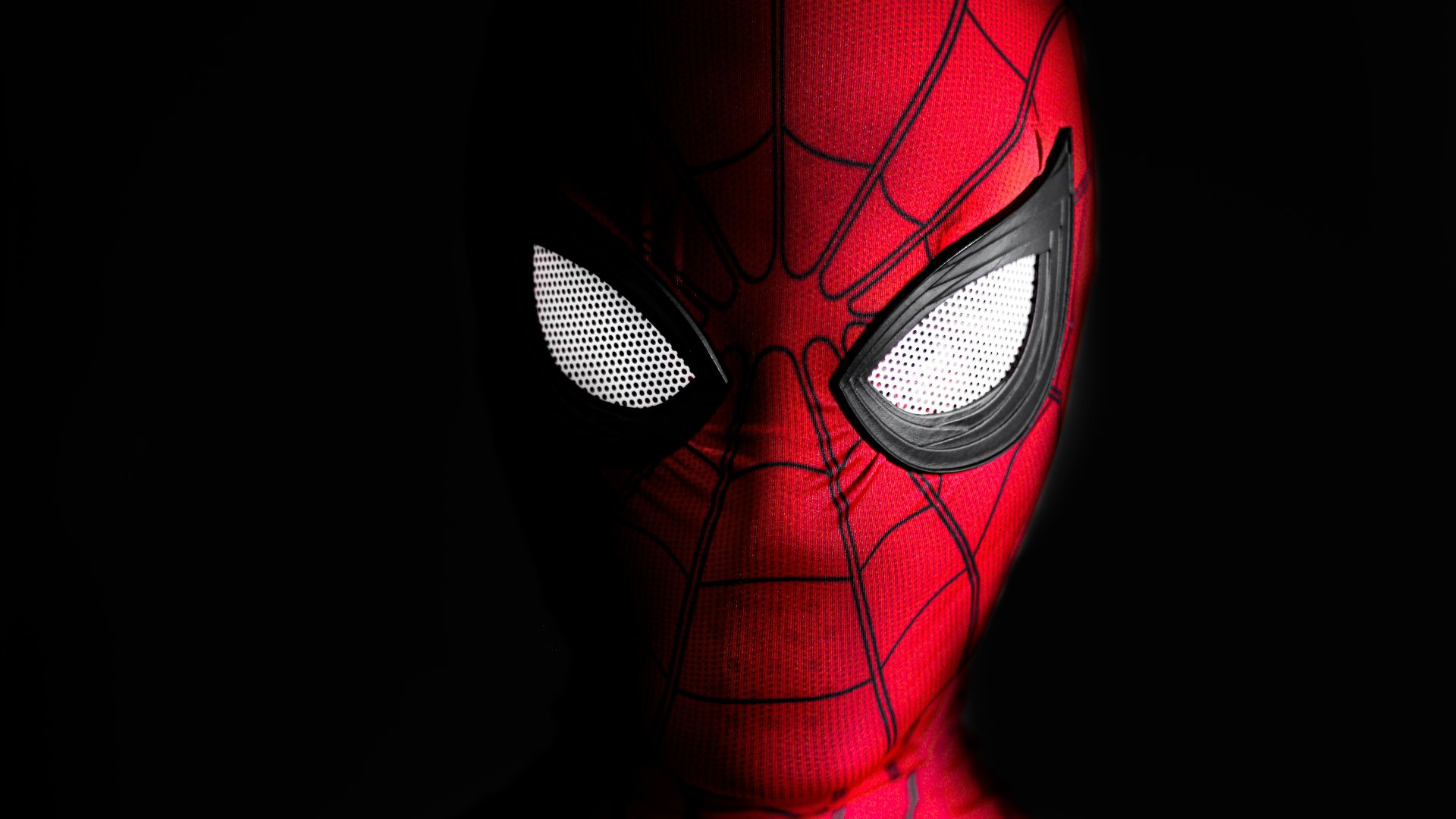 a close up of a spider man with glowing eyes