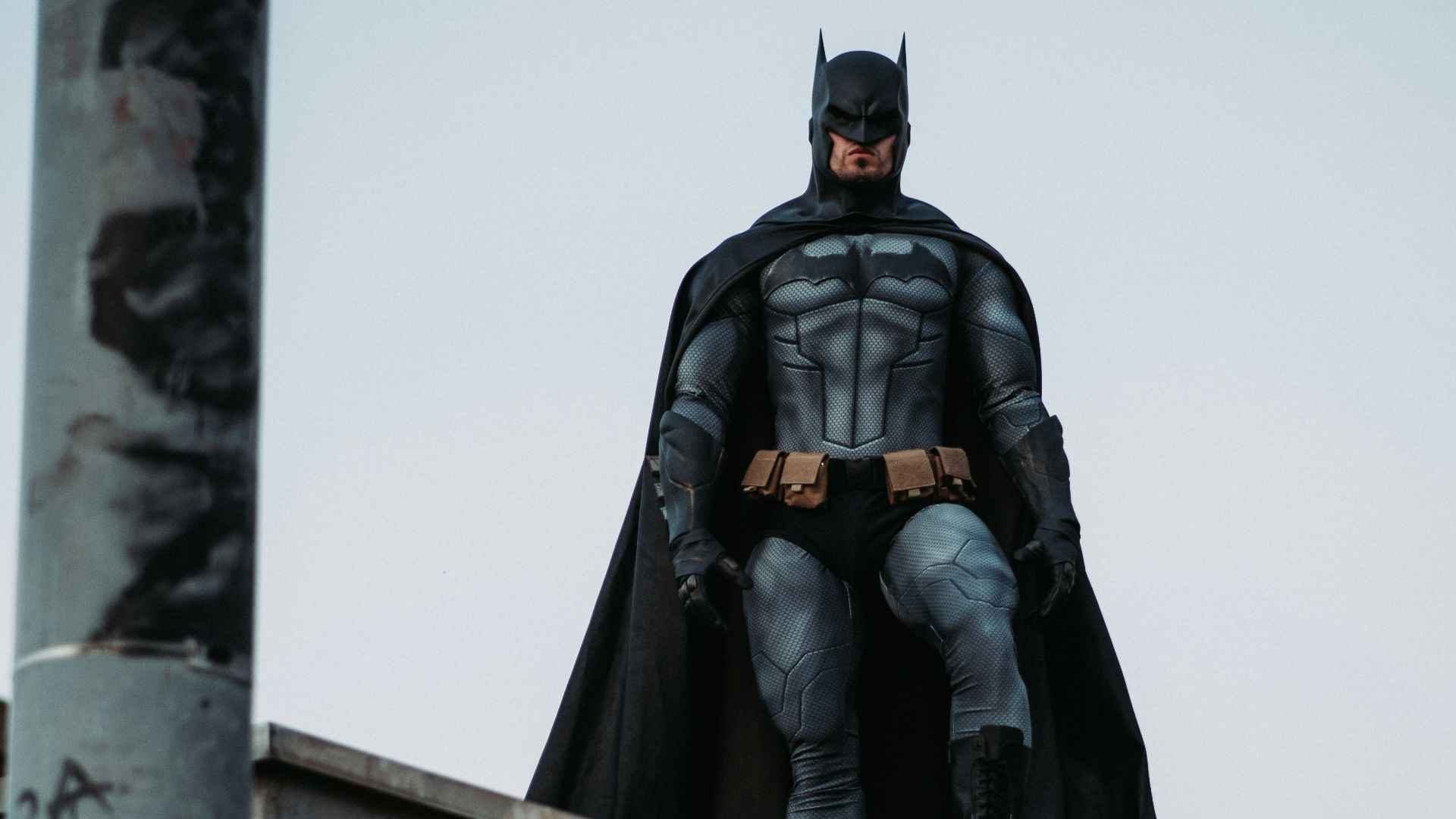 man in black jacket and pants standing on roof