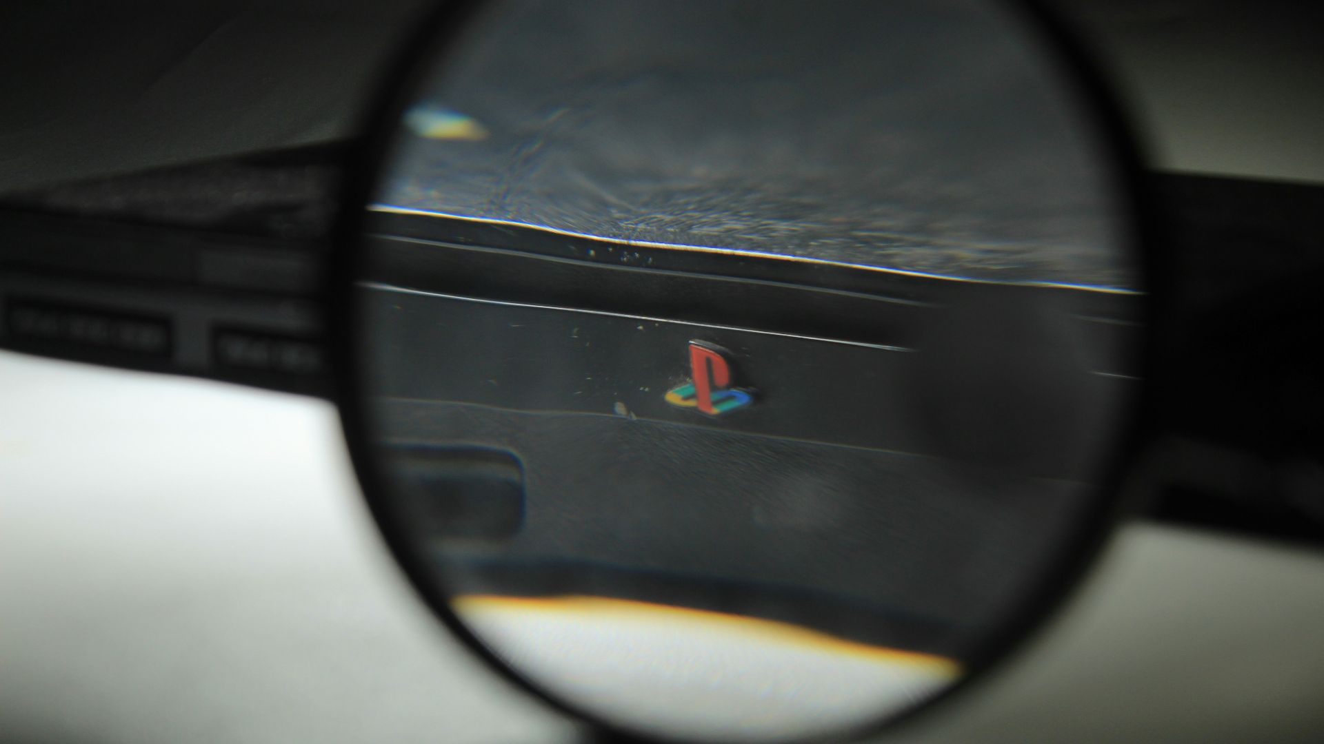 a close up of a magnifying glass with a logo on it
