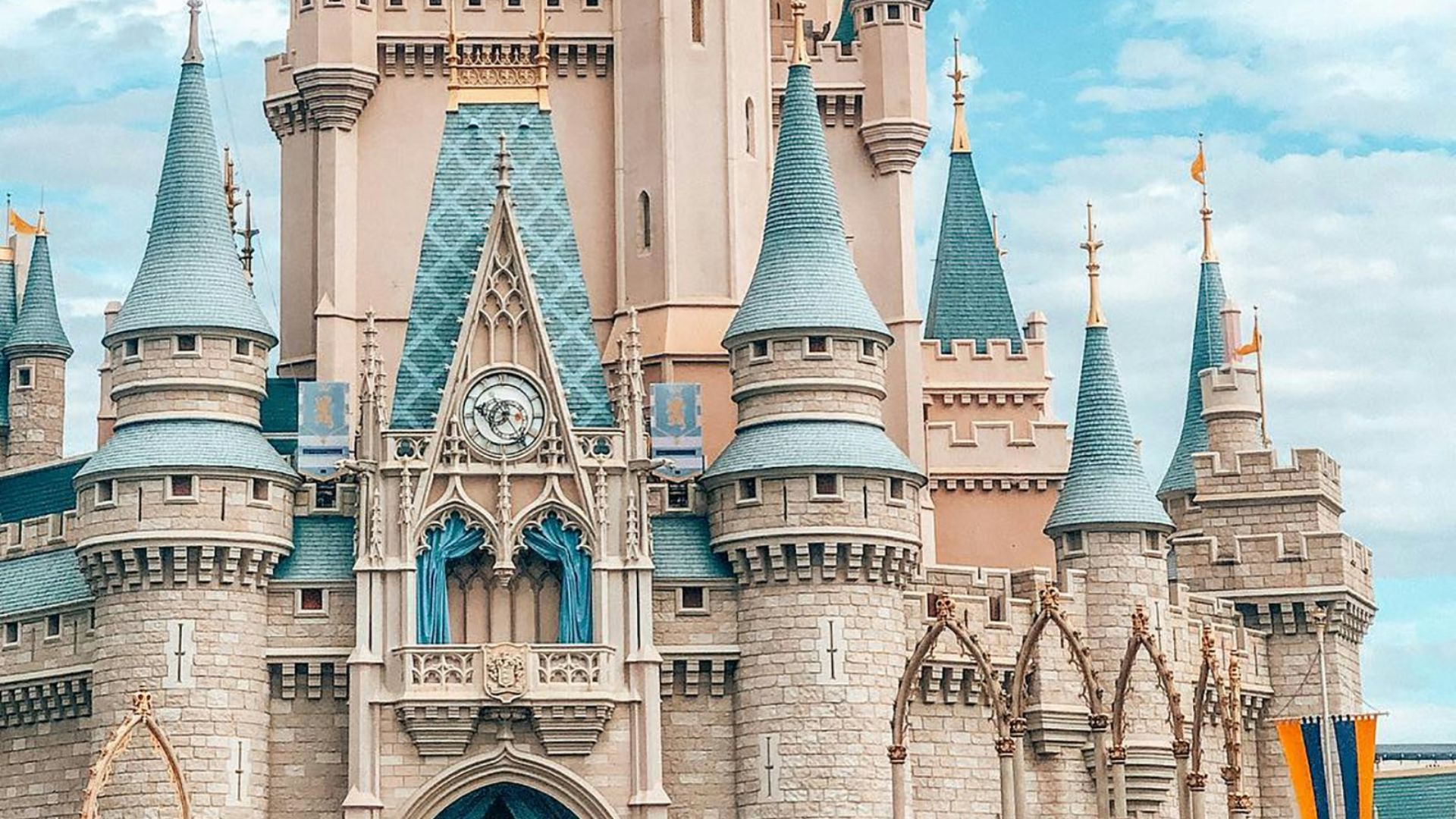 white and blue castle under blue sky and white clouds during daytime