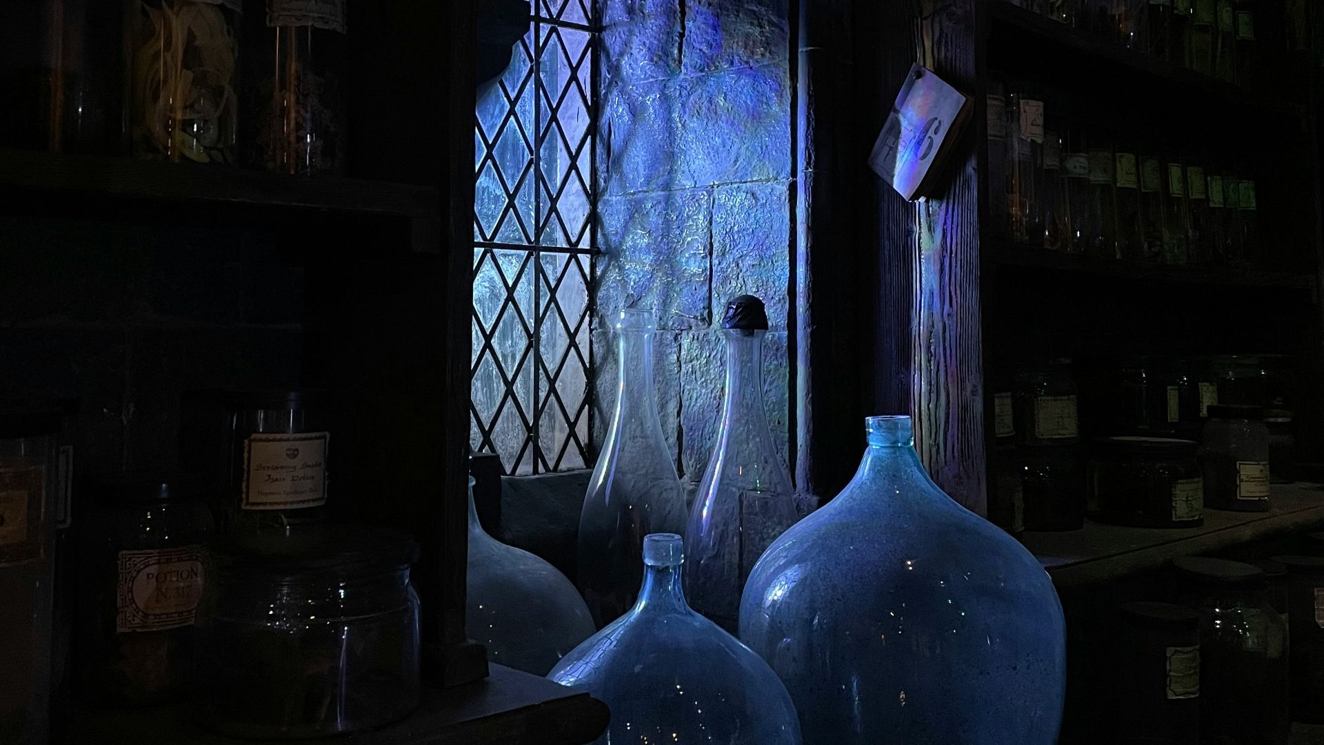 blue glass bottle on brown wooden shelf