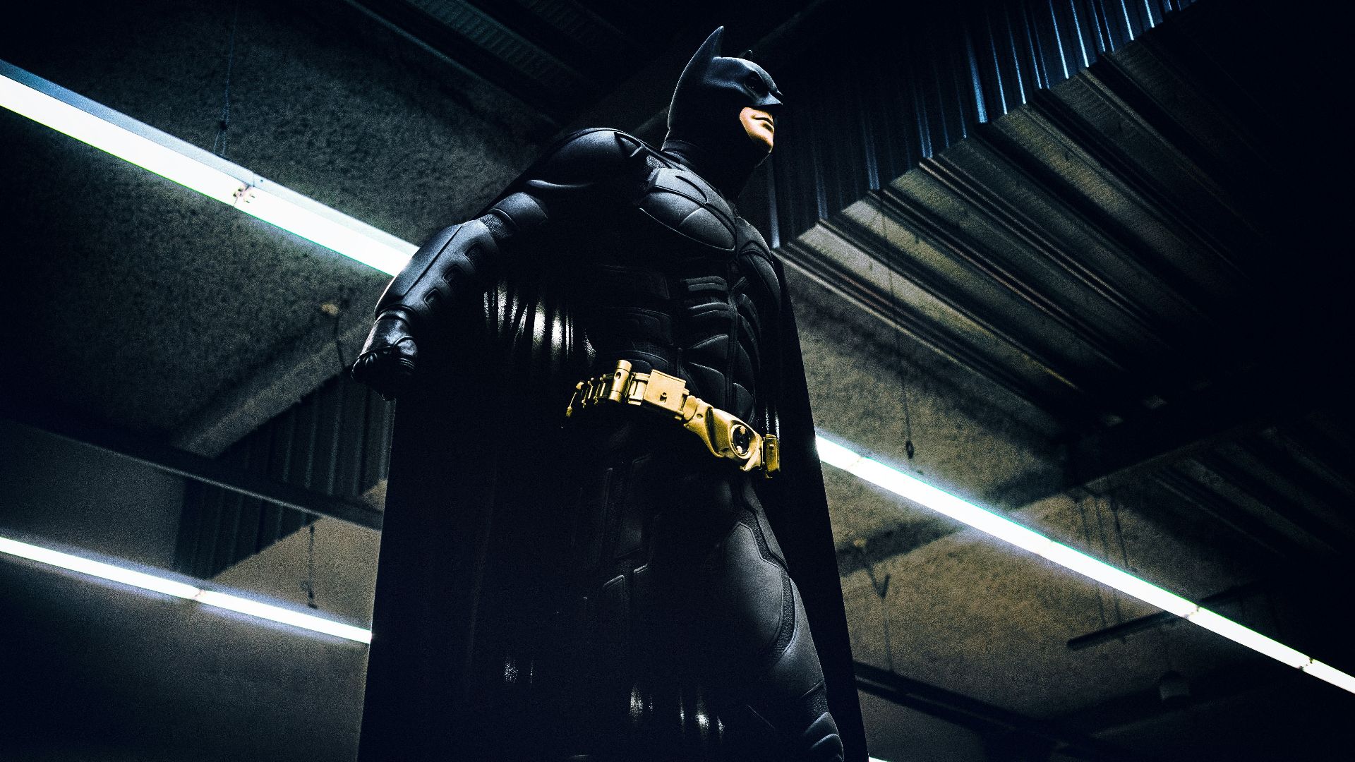 Batman standing under steel roof