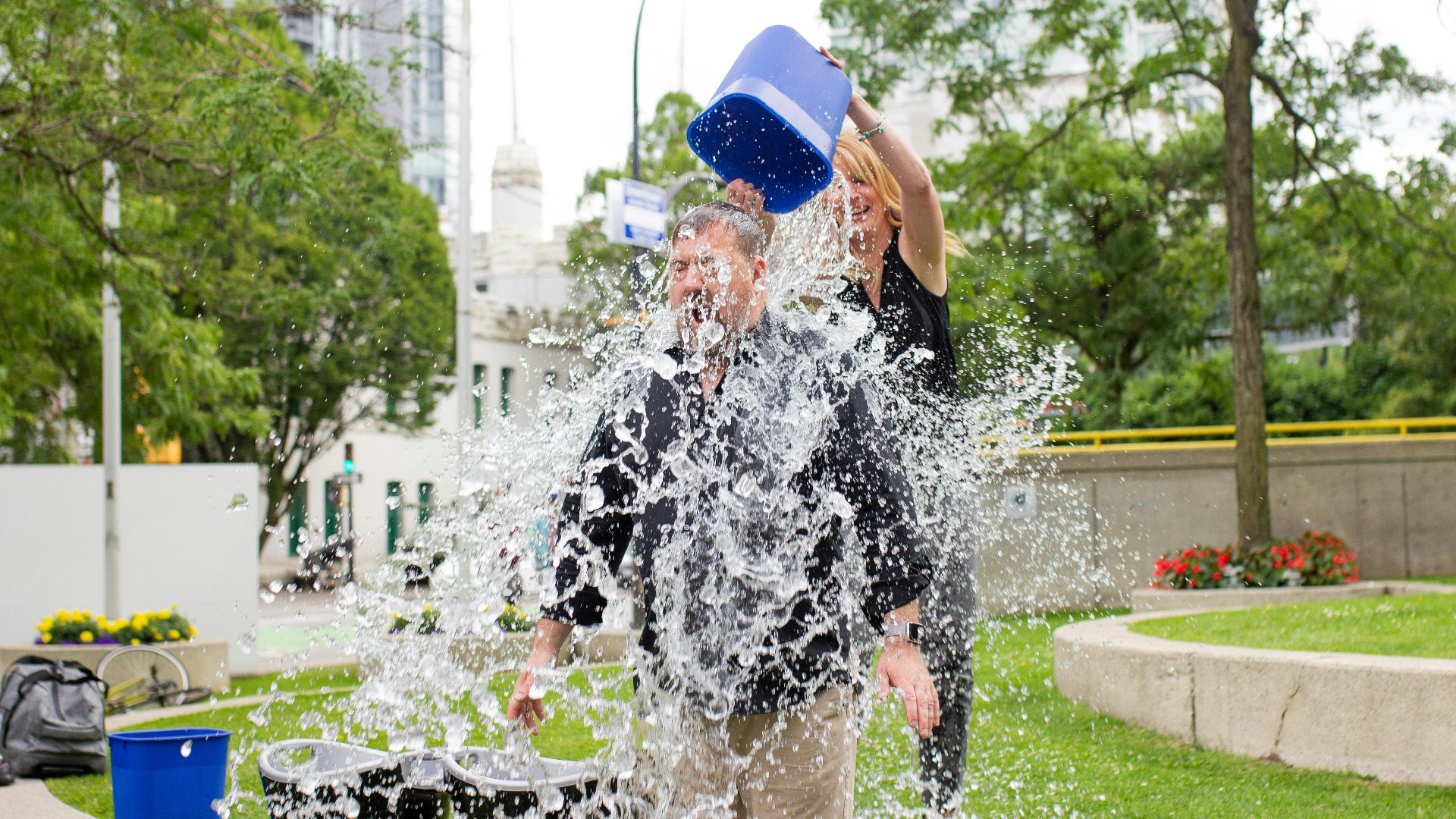 person pouring water to man