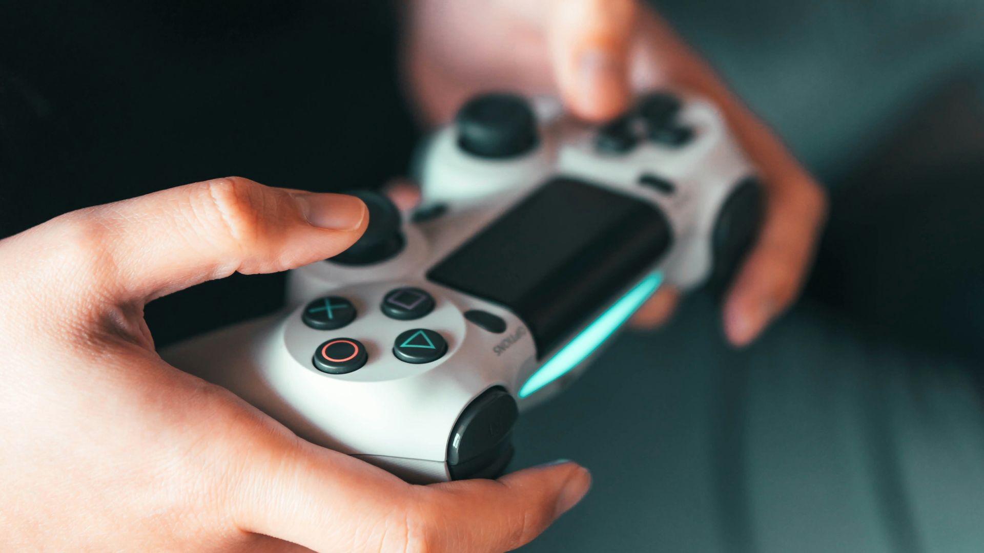 person holding gray game controller
