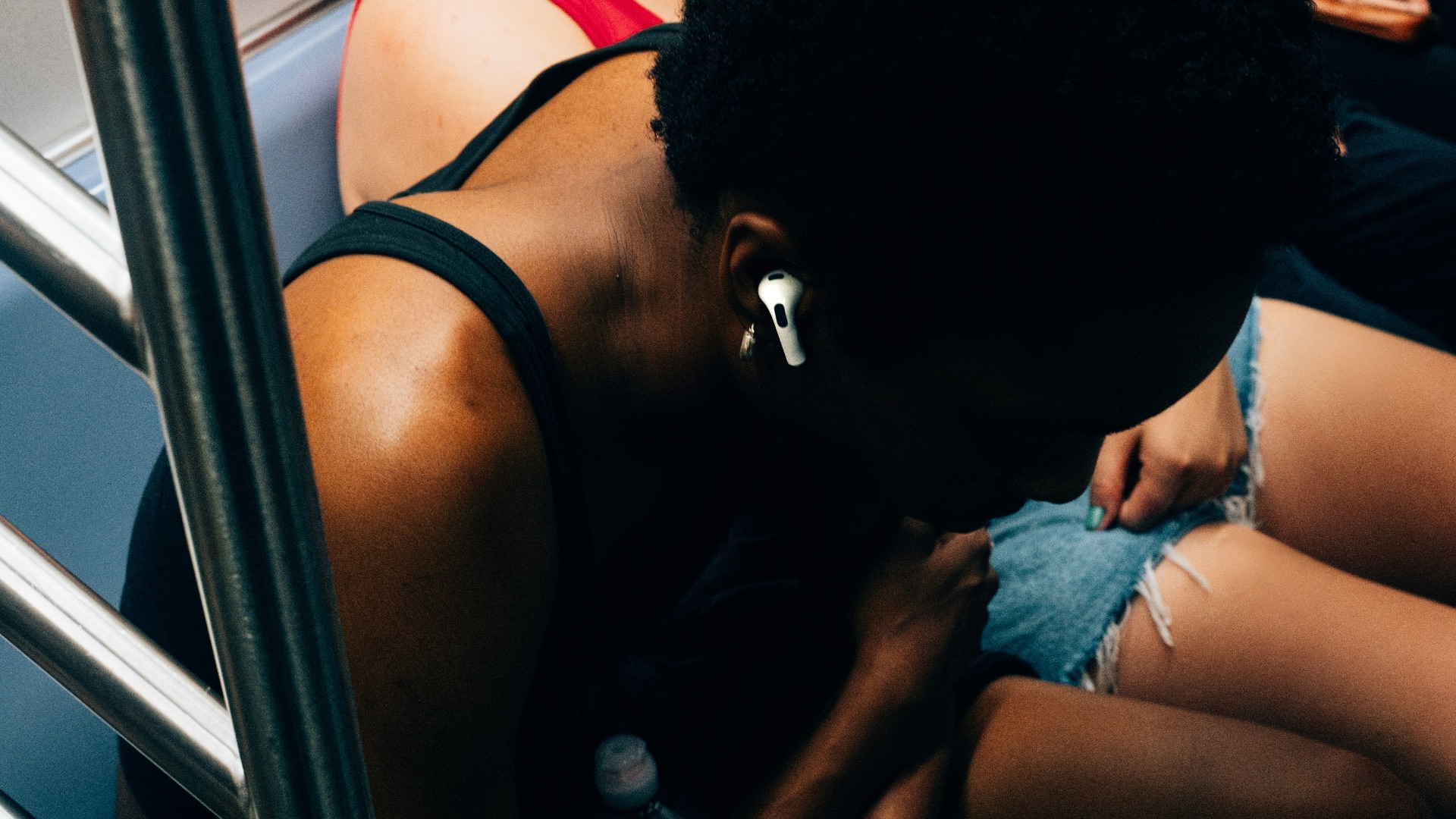 a woman sitting on a bus looking down at her phone