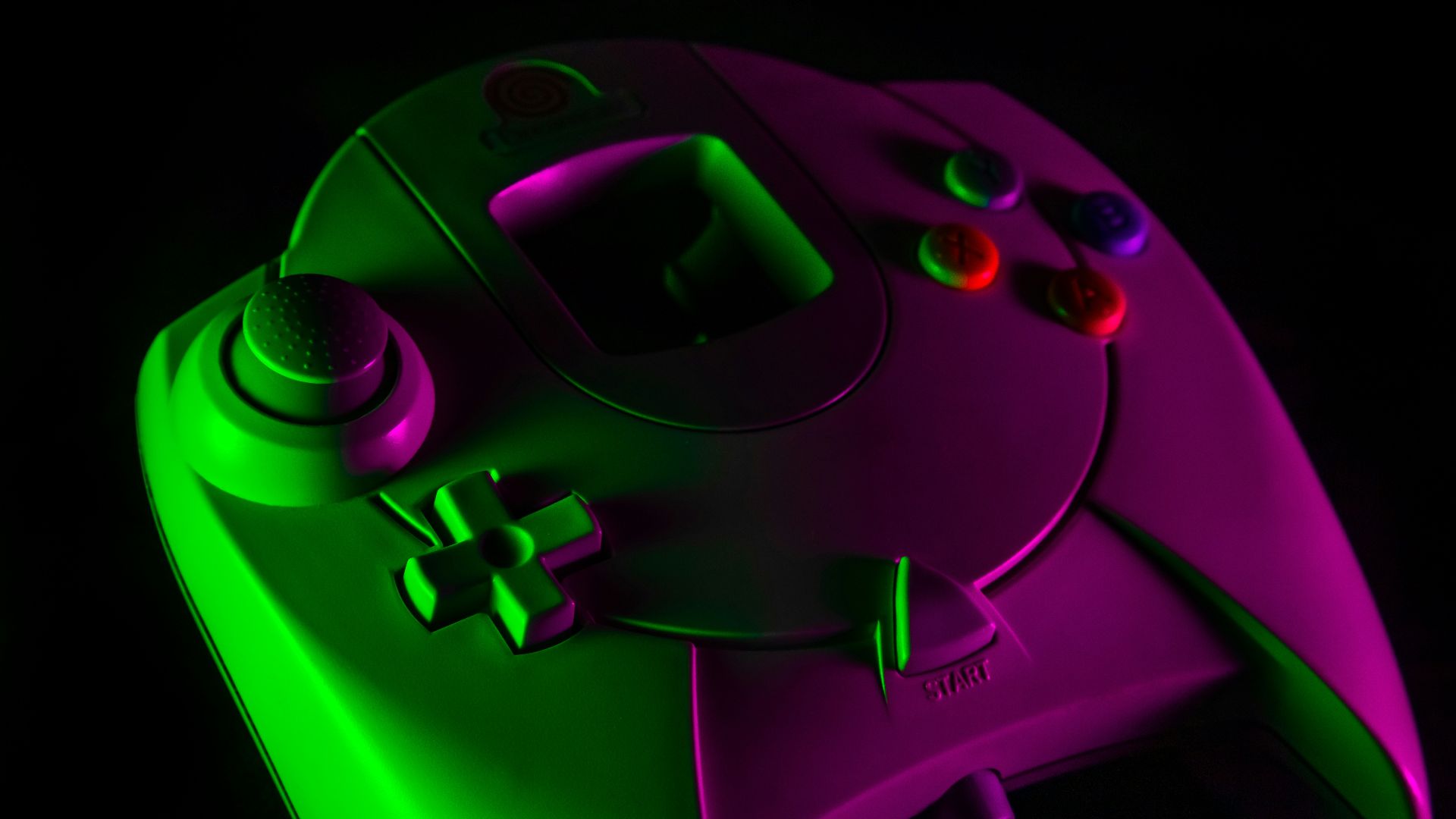 purple game controller on black surface