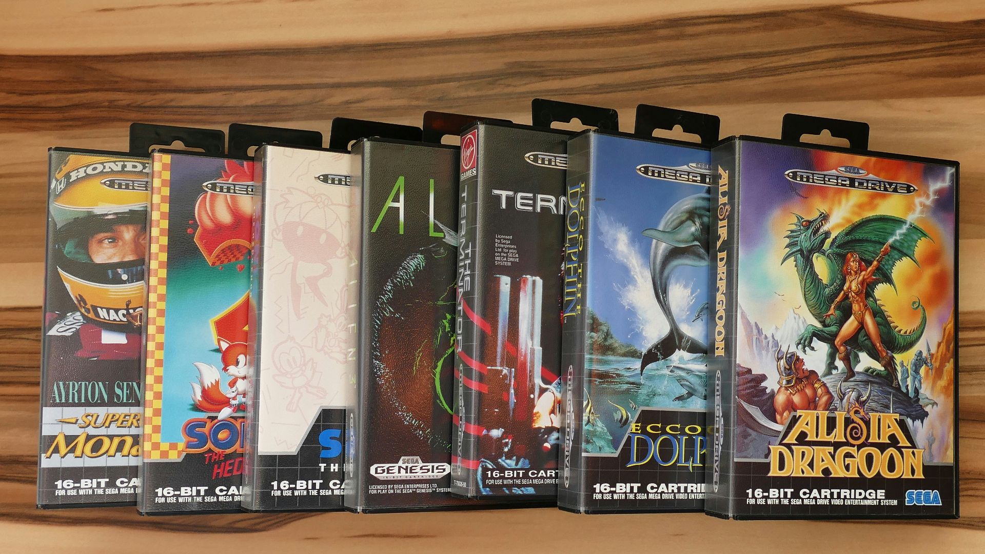 a row of nintendo games sitting on top of a wooden shelf